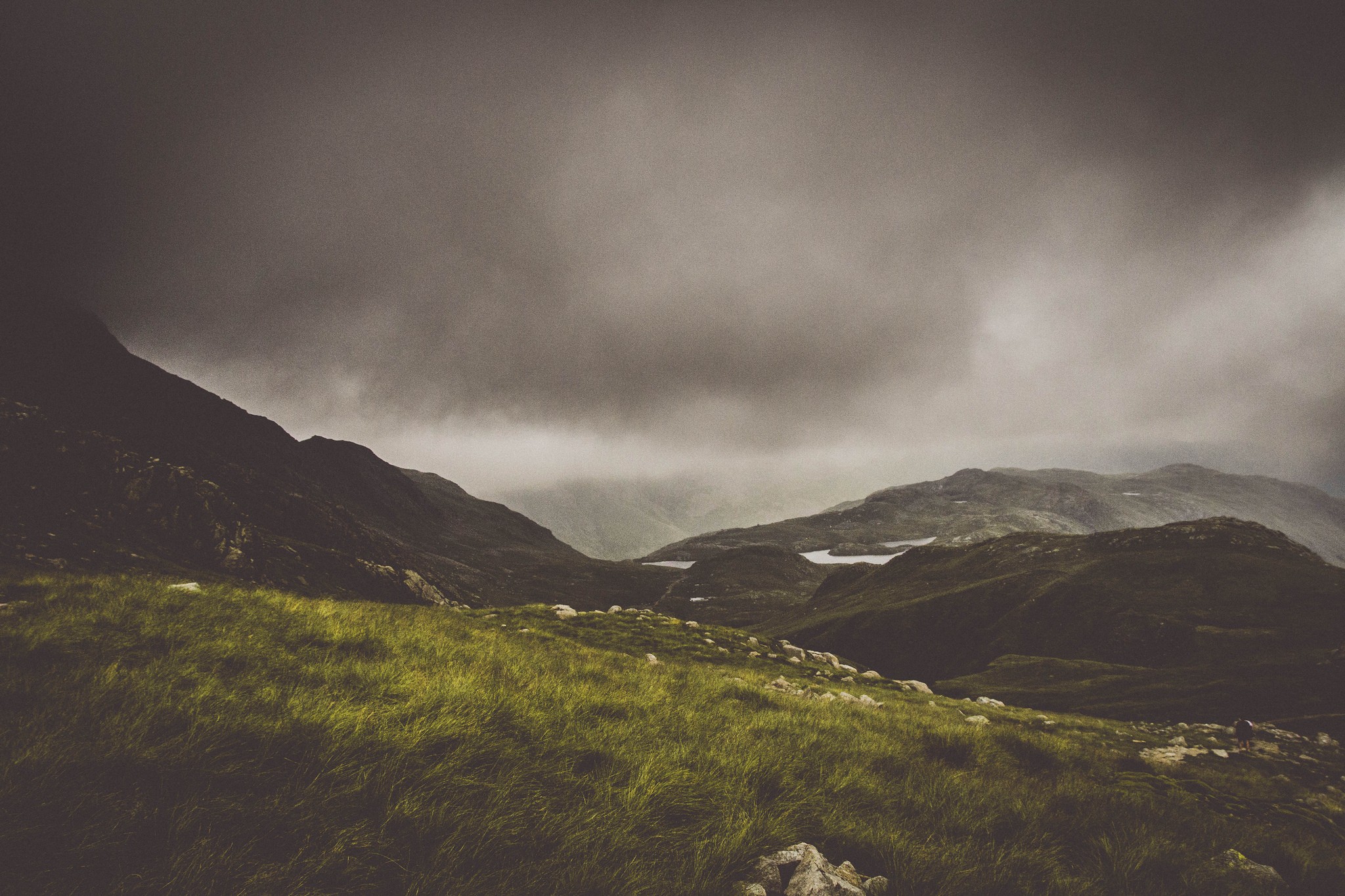 Mountains and lakes under a cloudy sky HD Wallpaper