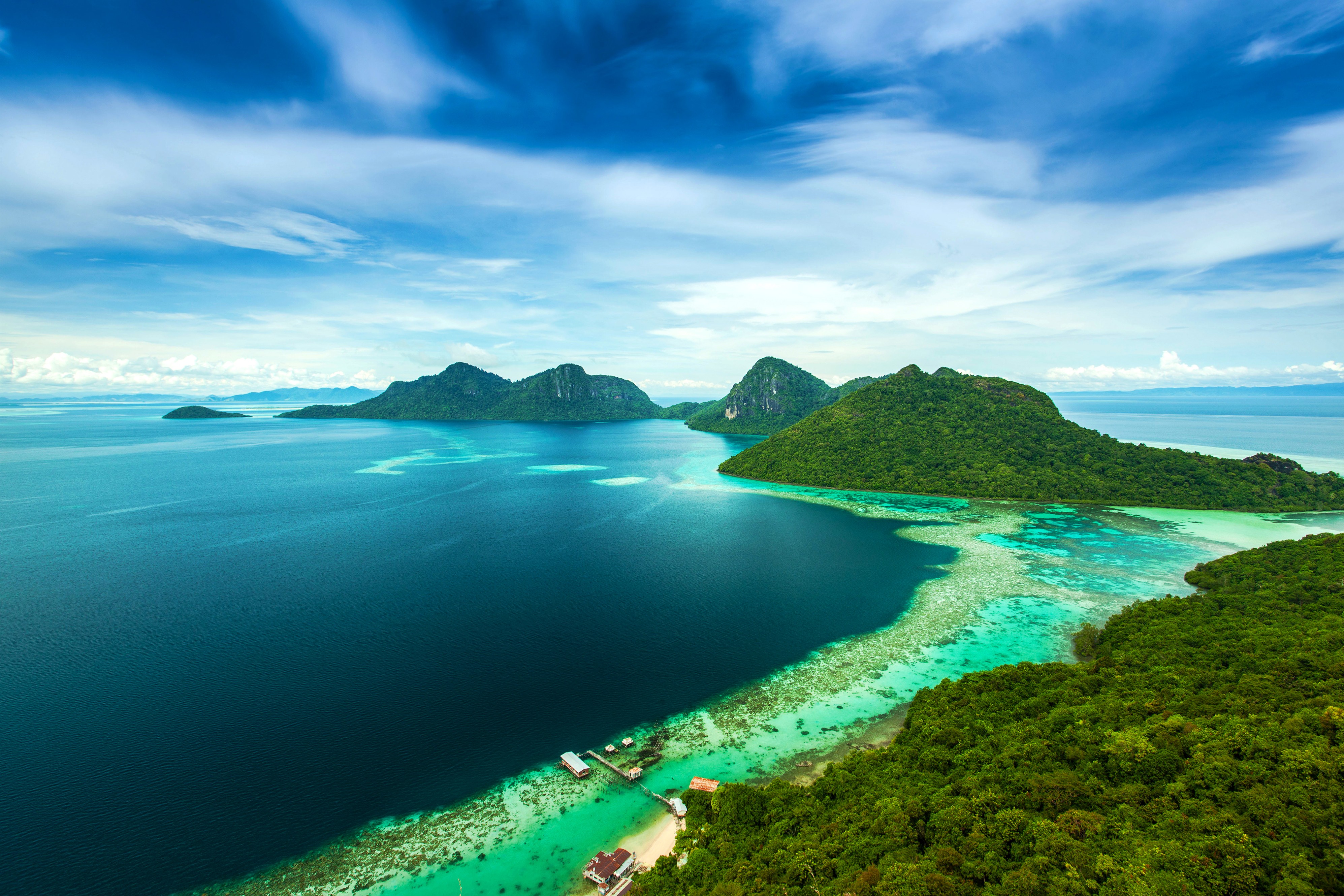 Islands and turquoise water in a tropical archipelago HD Wallpaper
