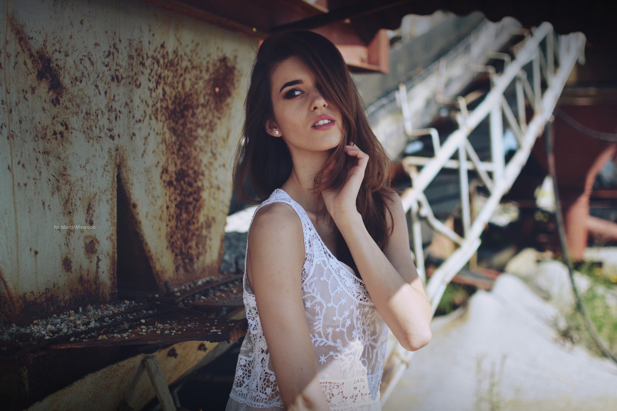 Brunette woman in white clothing in urban decay setting HD Wallpaper