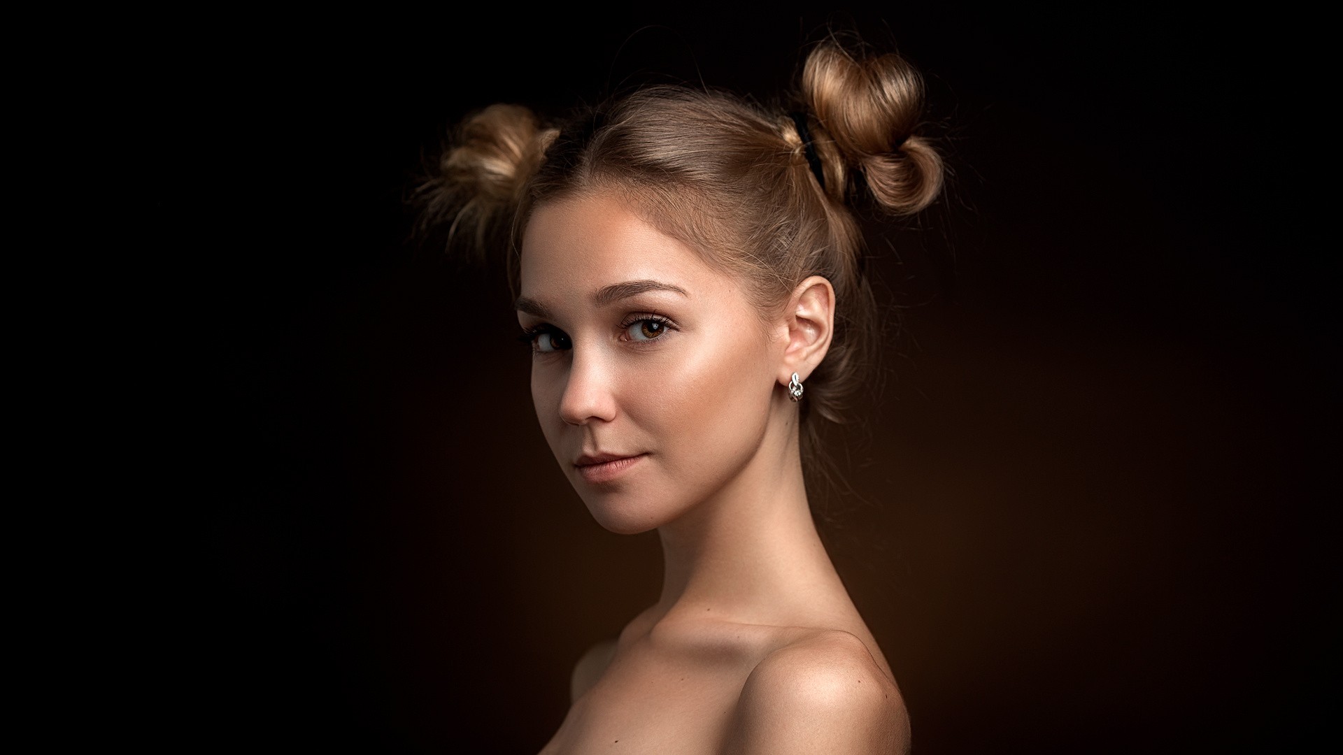 Portrait of a young woman with buns HD Wallpaper