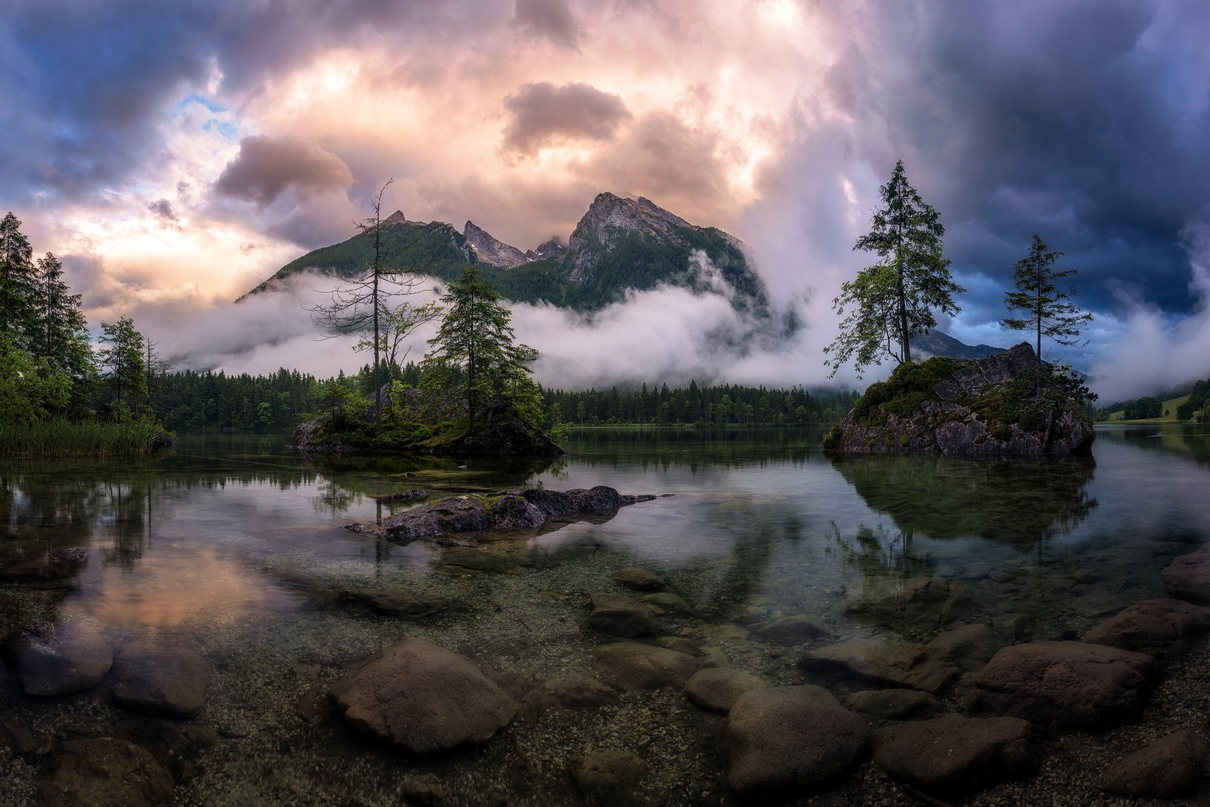 Lake with mountains and trees under dramatic clouds HD Wallpaper
