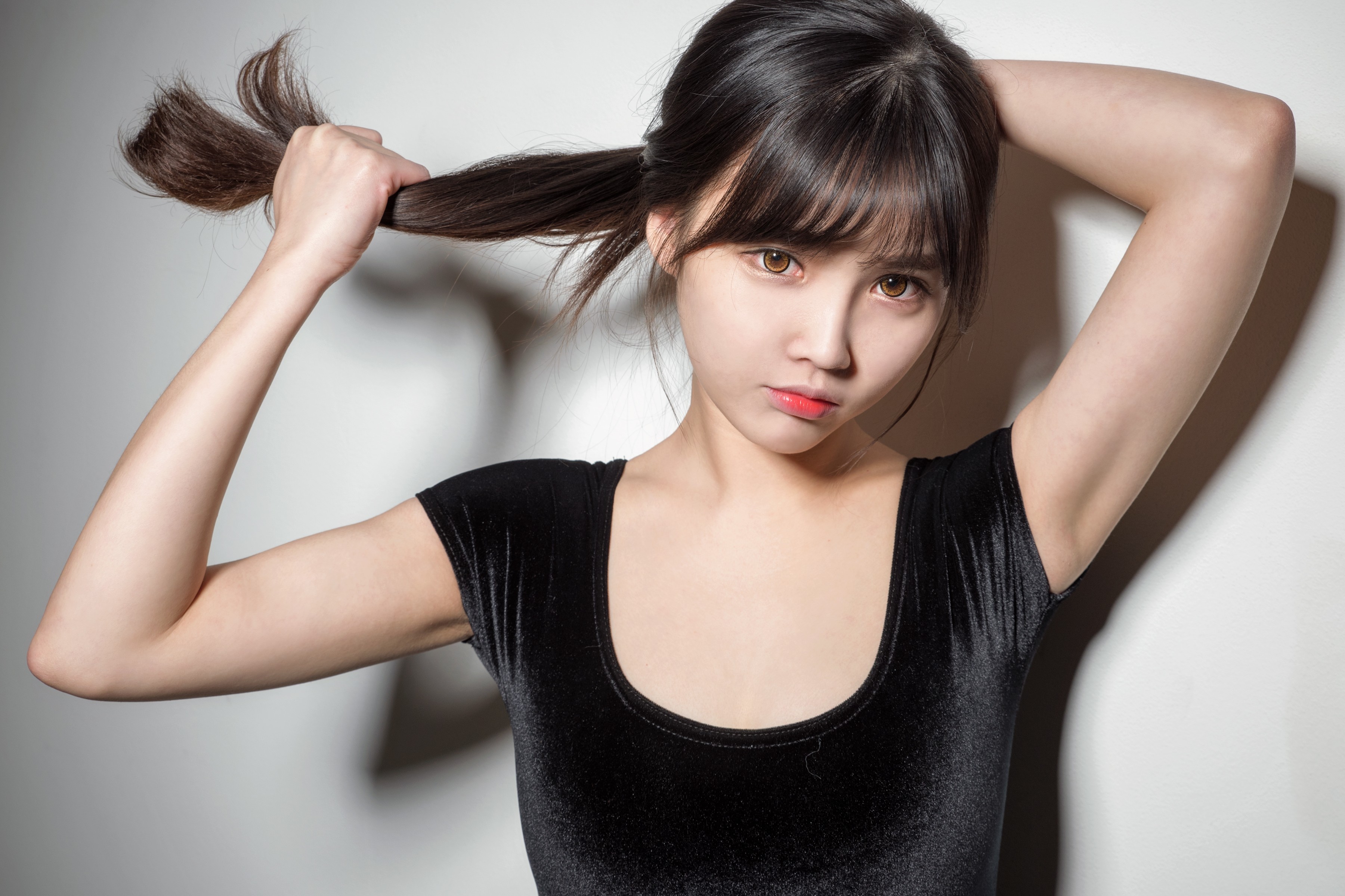 Asian woman pulling her hair HD Wallpaper