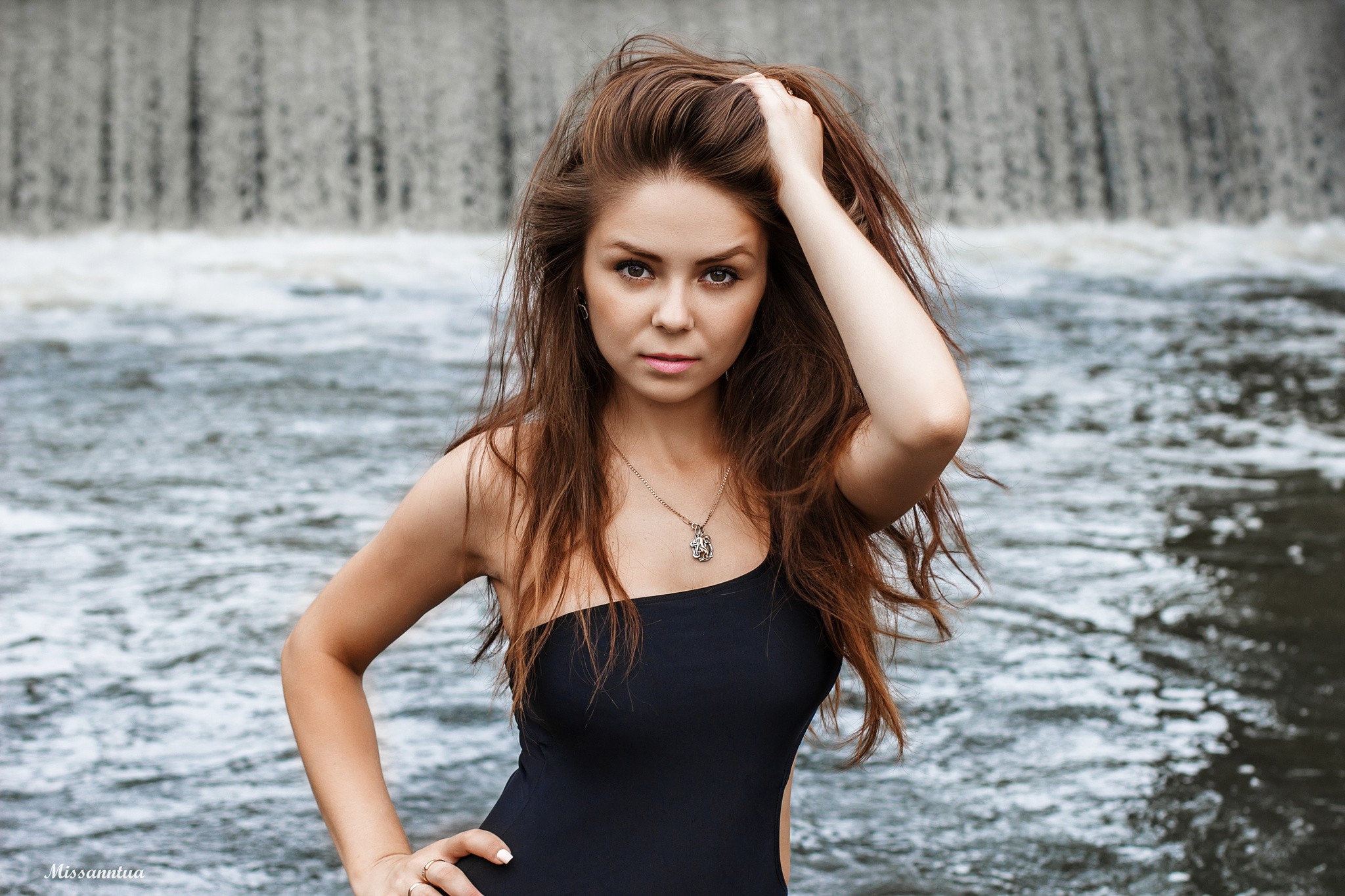 Woman with long brown hair at a waterfall HD Wallpaper