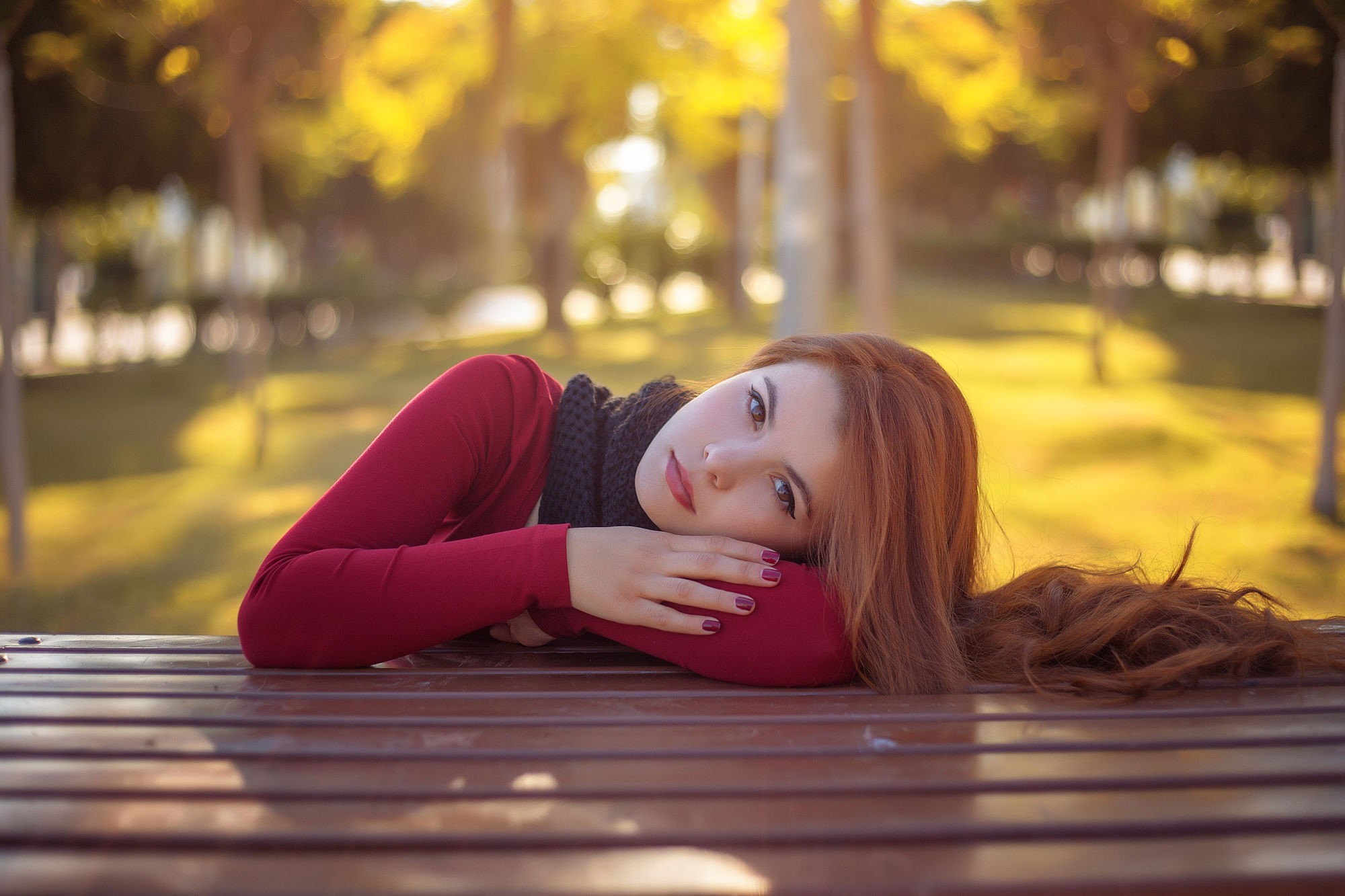 Woman with red hair lying on a table outdoors HD Wallpaper