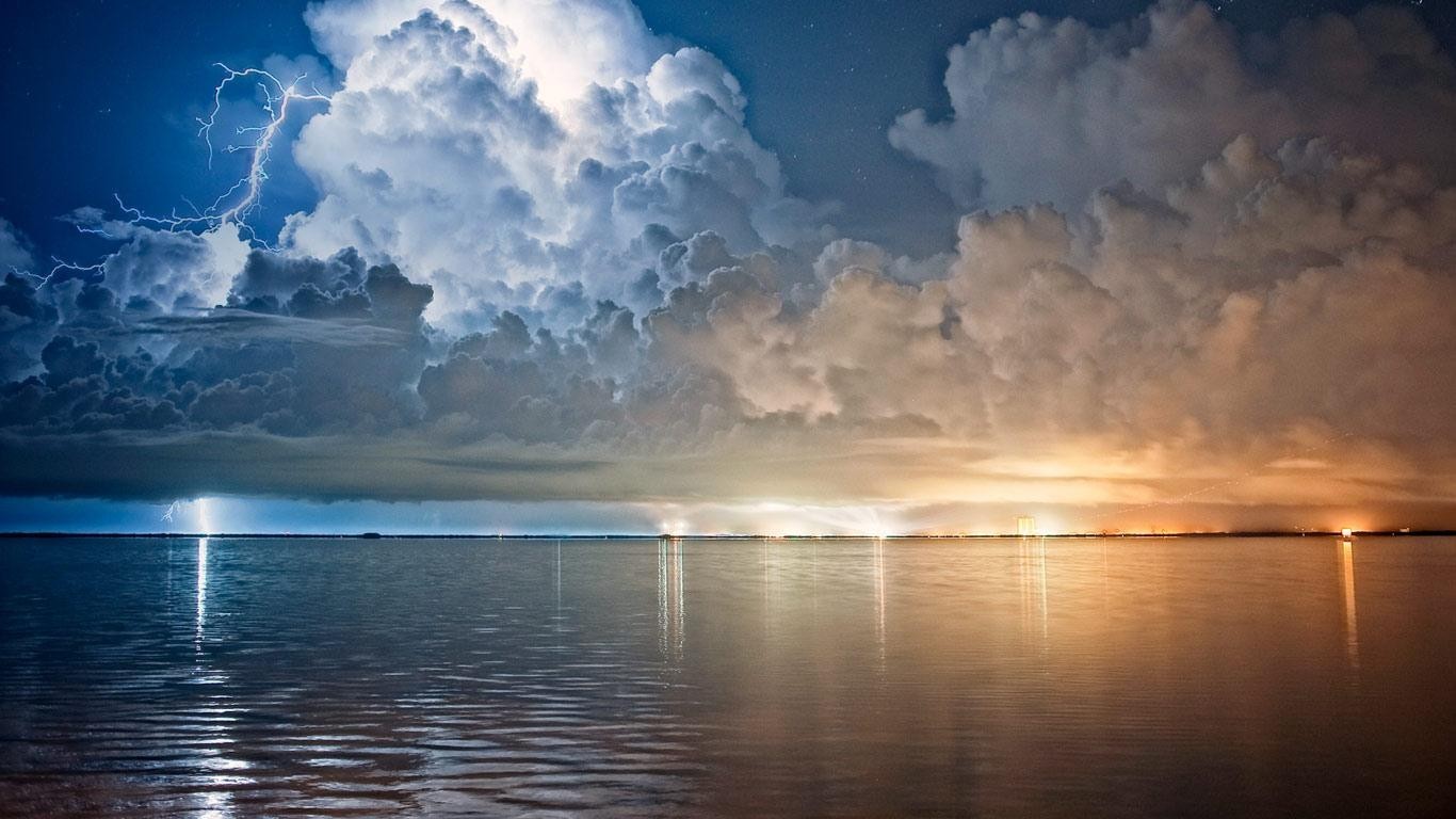 Lightning strikes over the sea at night HD Wallpaper