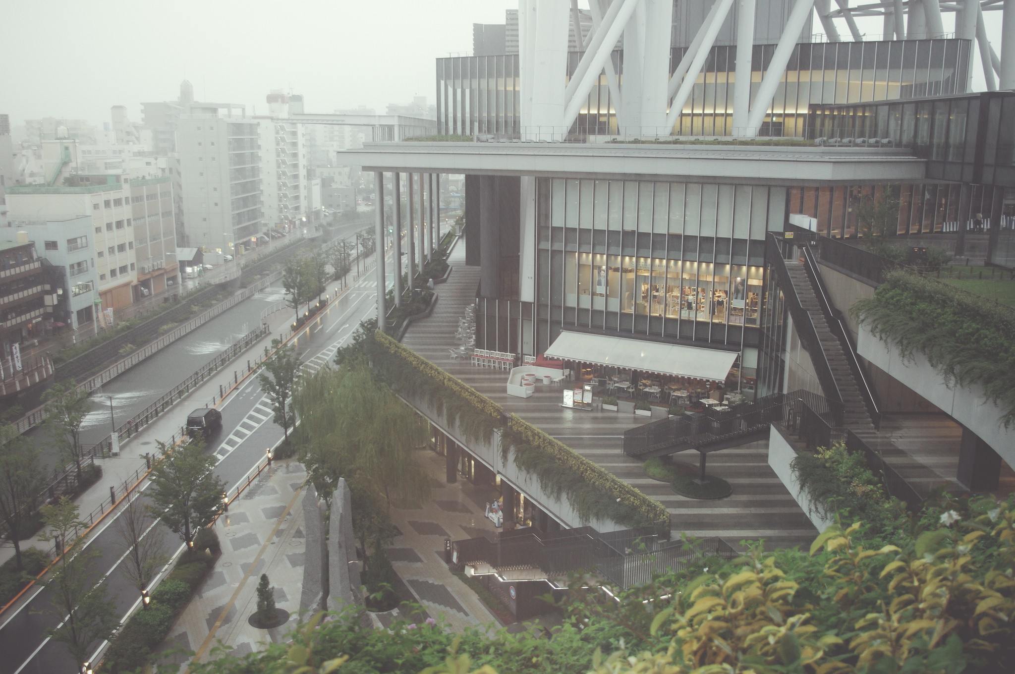 Cityscape with buildings and a street in the mist HD Wallpaper