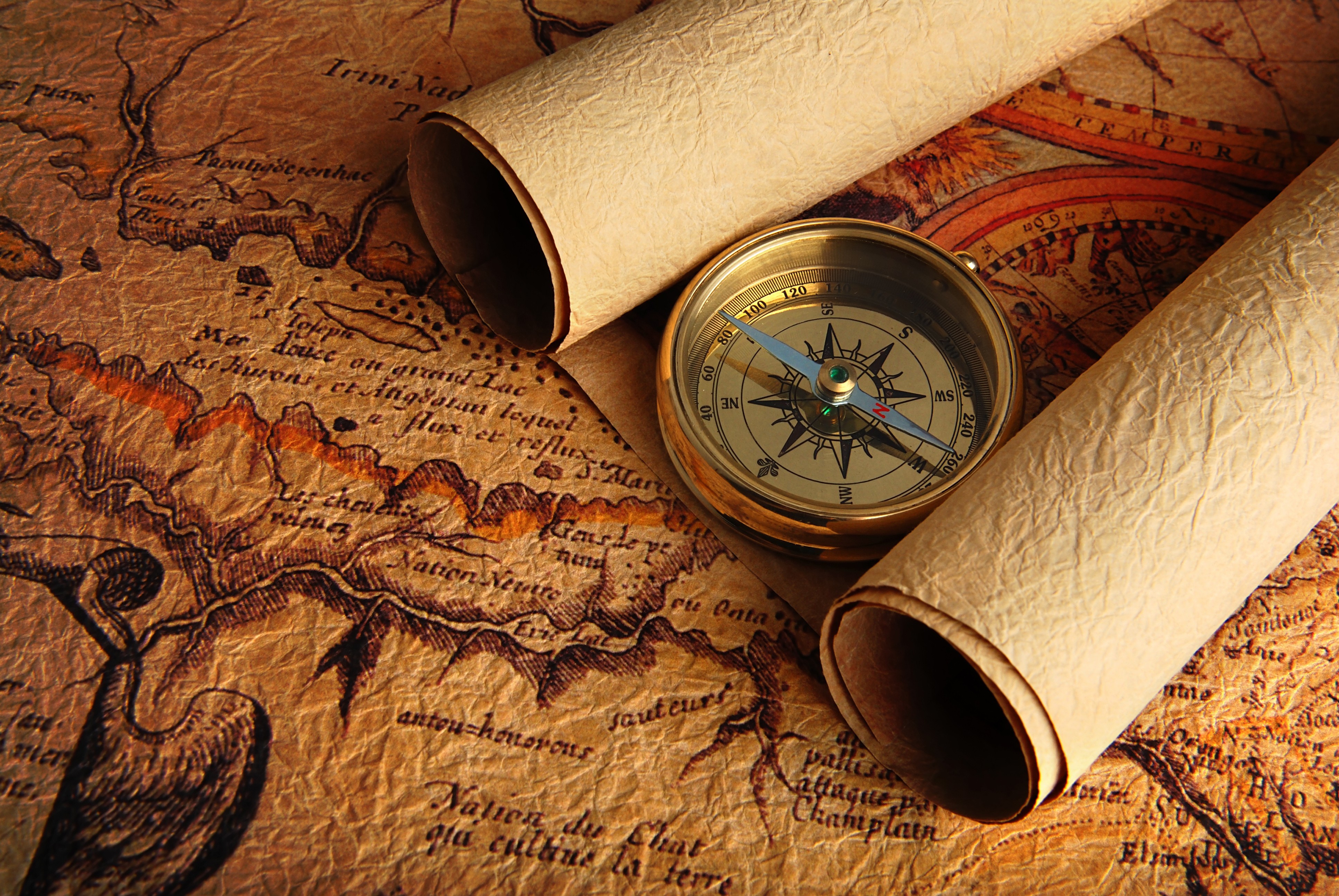 Antique map with compass and rolled scrolls HD Wallpaper