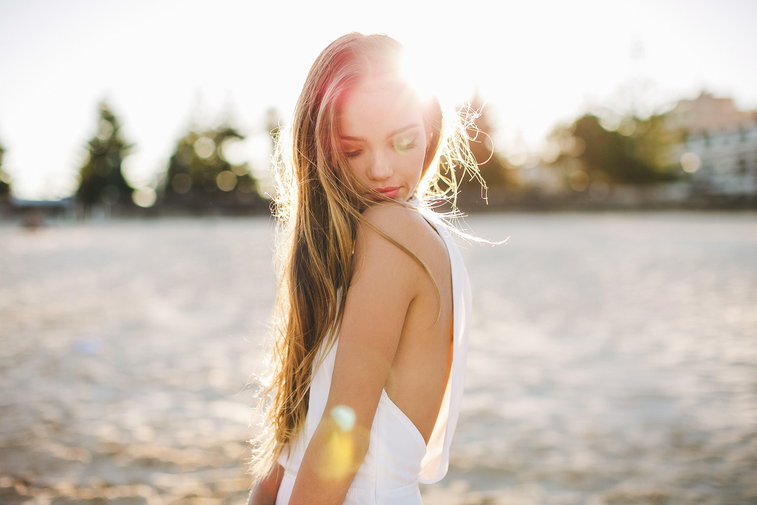 Woman in white dress on a beach at sunset HD Wallpaper