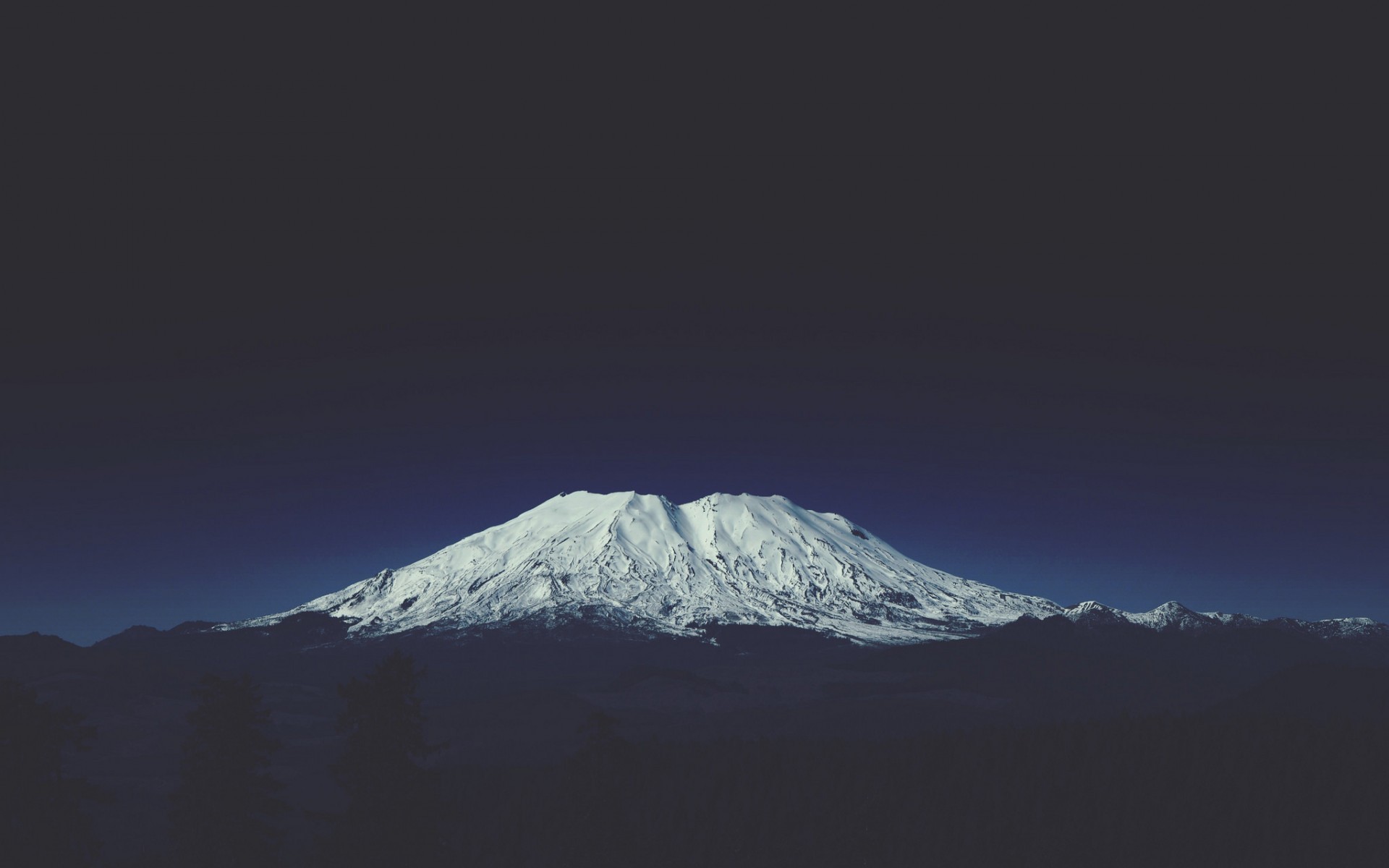 Snow-capped mountain under a dark blue sky HD Wallpaper