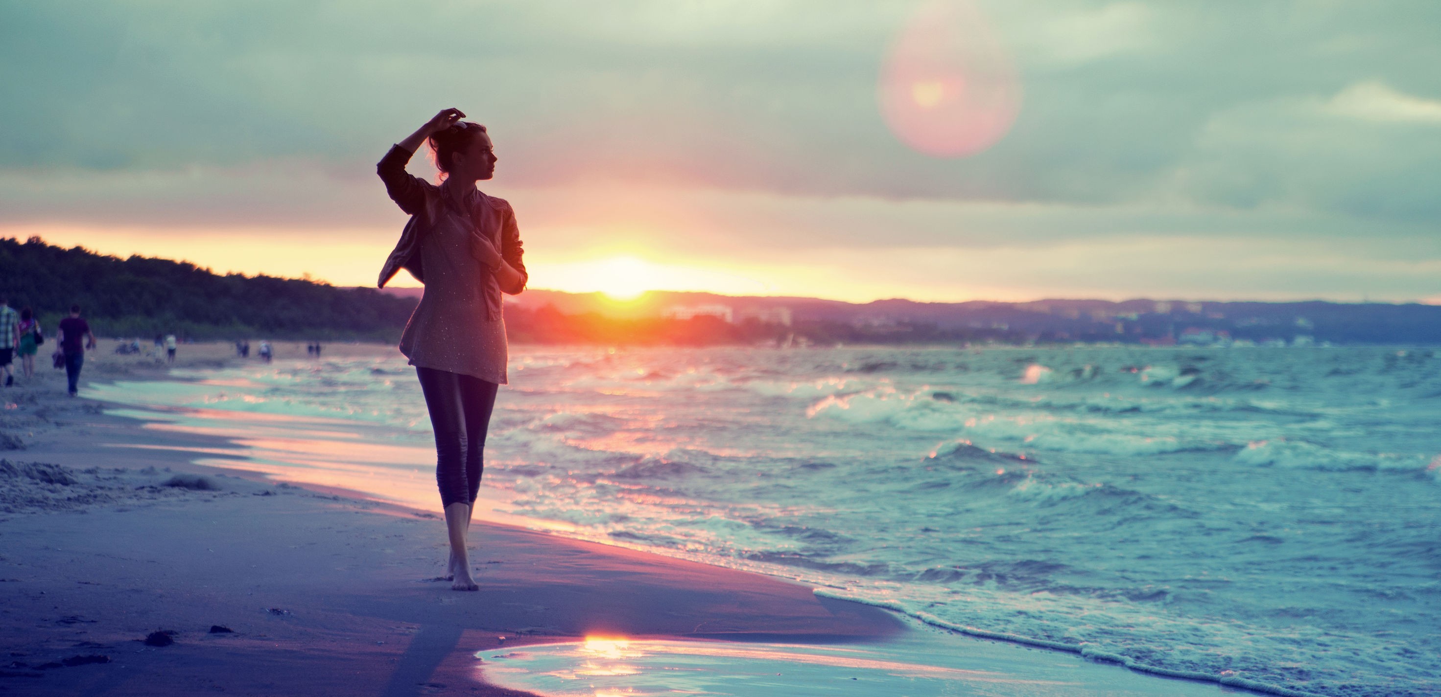 Woman walking on a beach at sunset HD Wallpaper