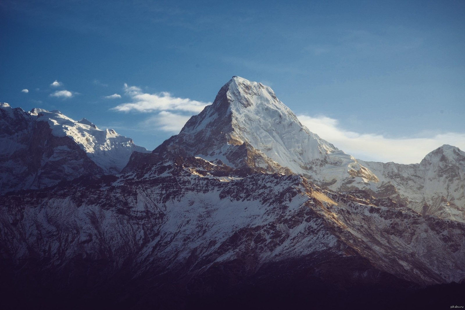 Snow-capped mountains under a blue sky HD Wallpaper