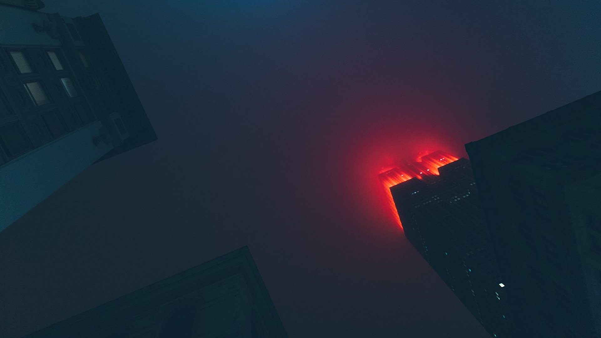 Skyscrapers at night with red mist HD Wallpaper