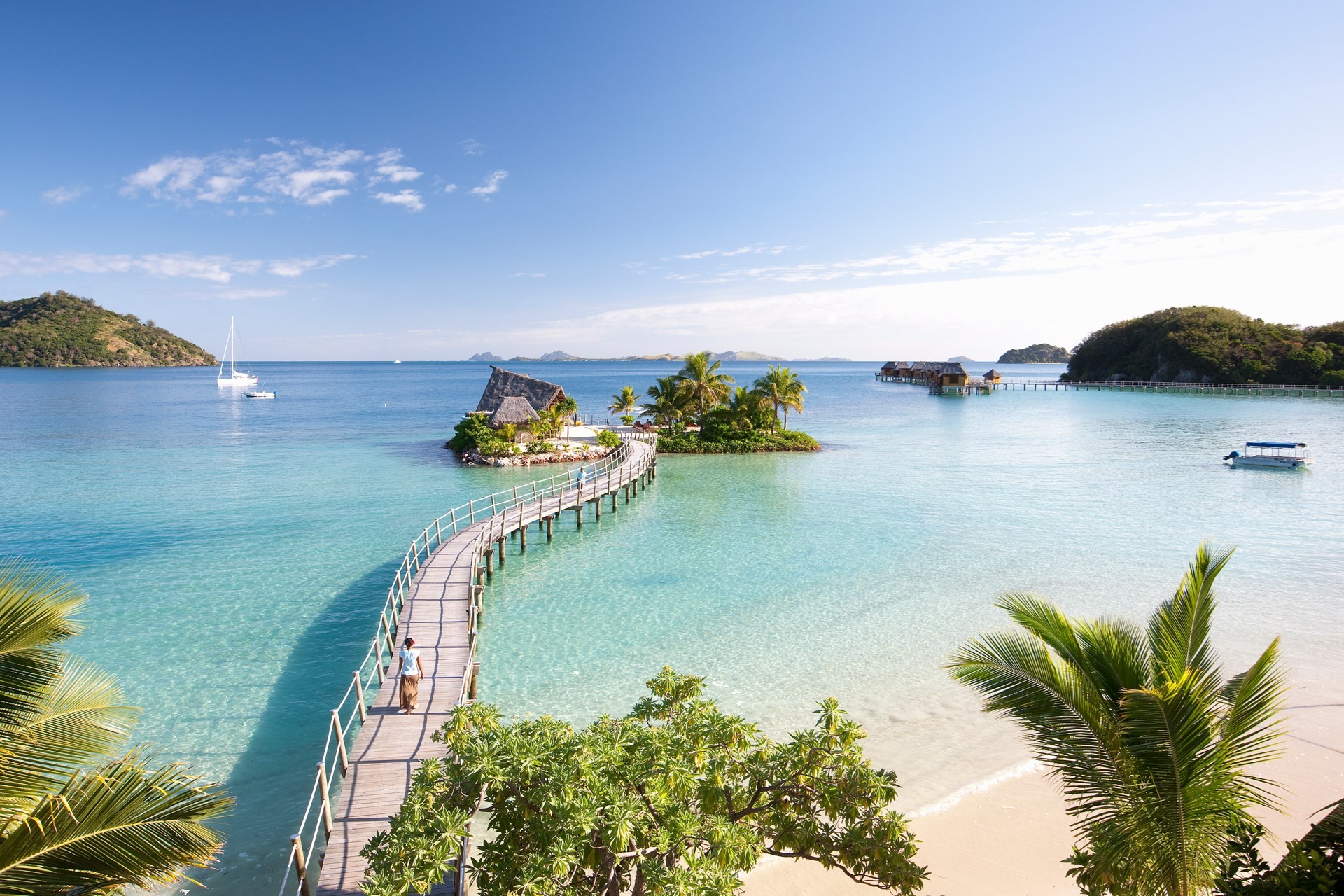 Wooden walkway to a small island with a hut in a tropical bay HD Wallpaper