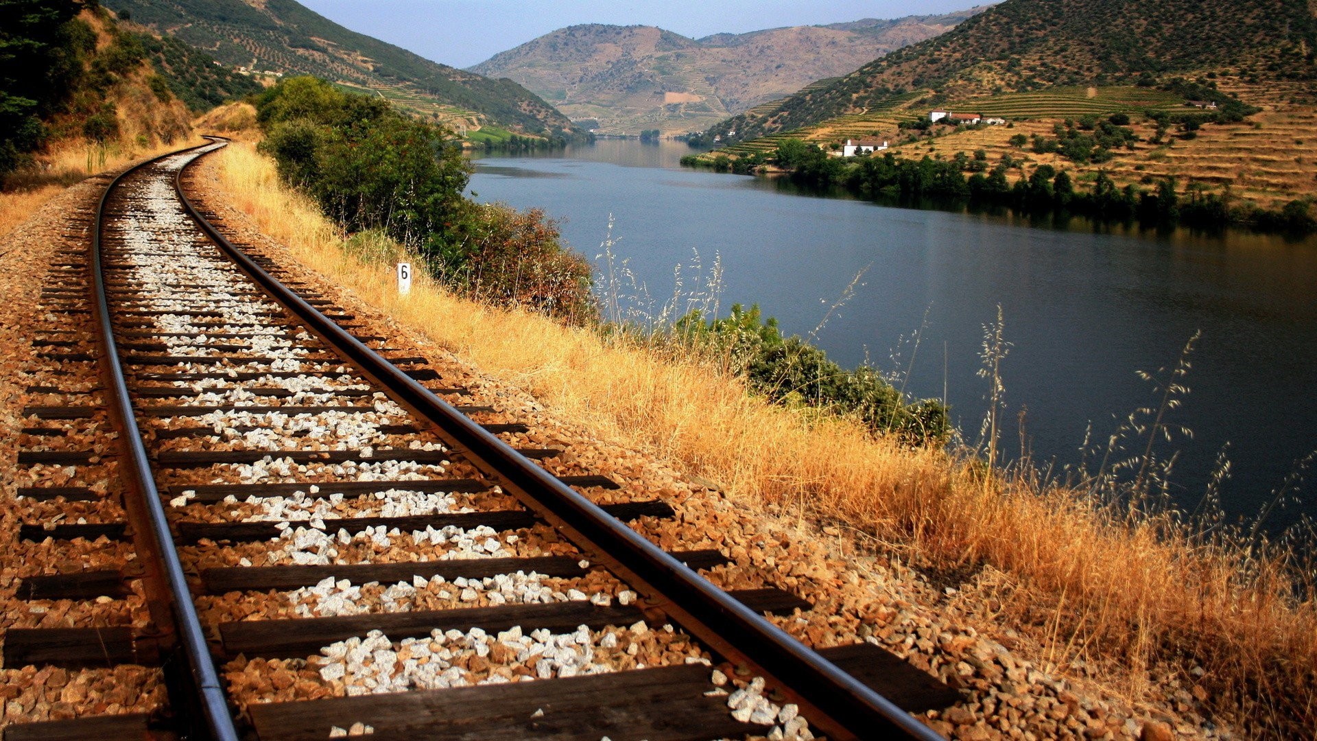 Railway tracks along a river valley HD Wallpaper