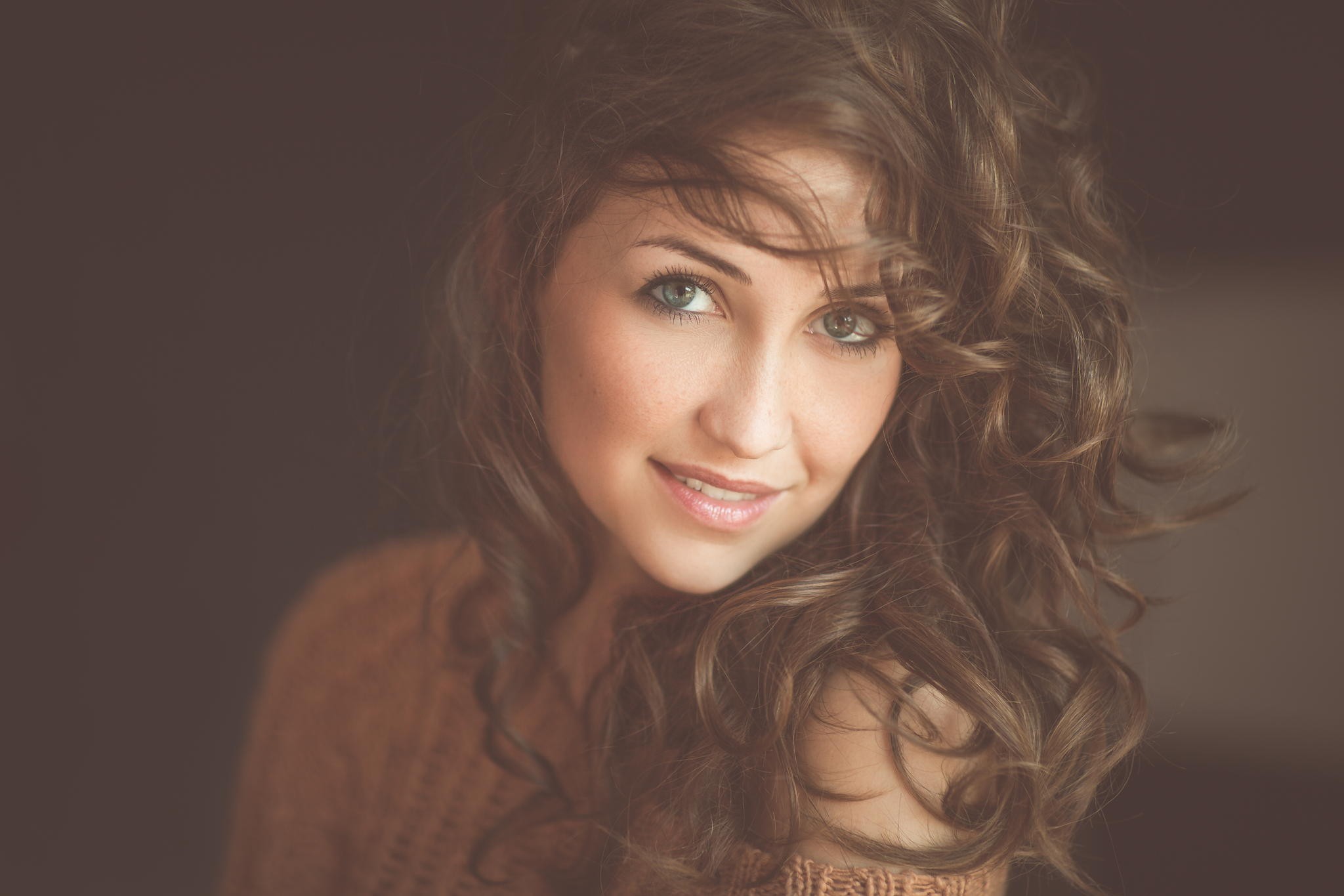 Portrait of a smiling woman with curly brown hair HD Wallpaper