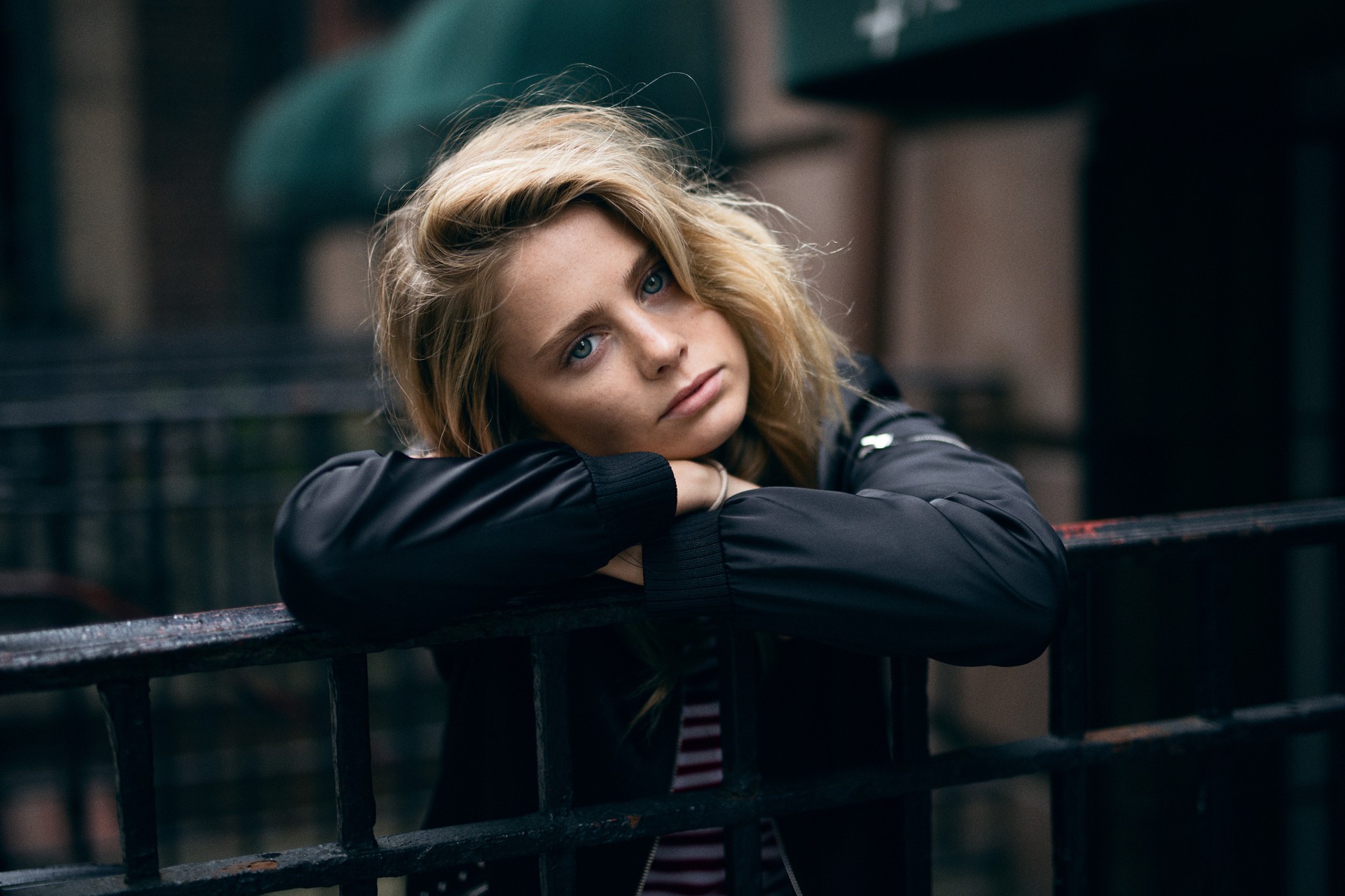 Blonde woman leaning on a fence outdoors HD Wallpaper
