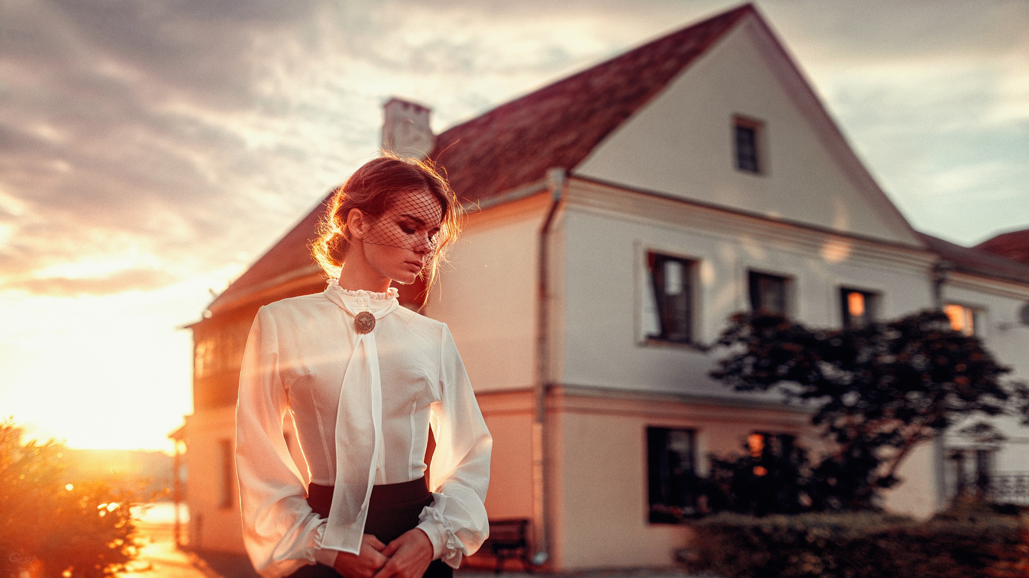 Woman in white blouse with veil in front of a house at sunset HD Wallpaper