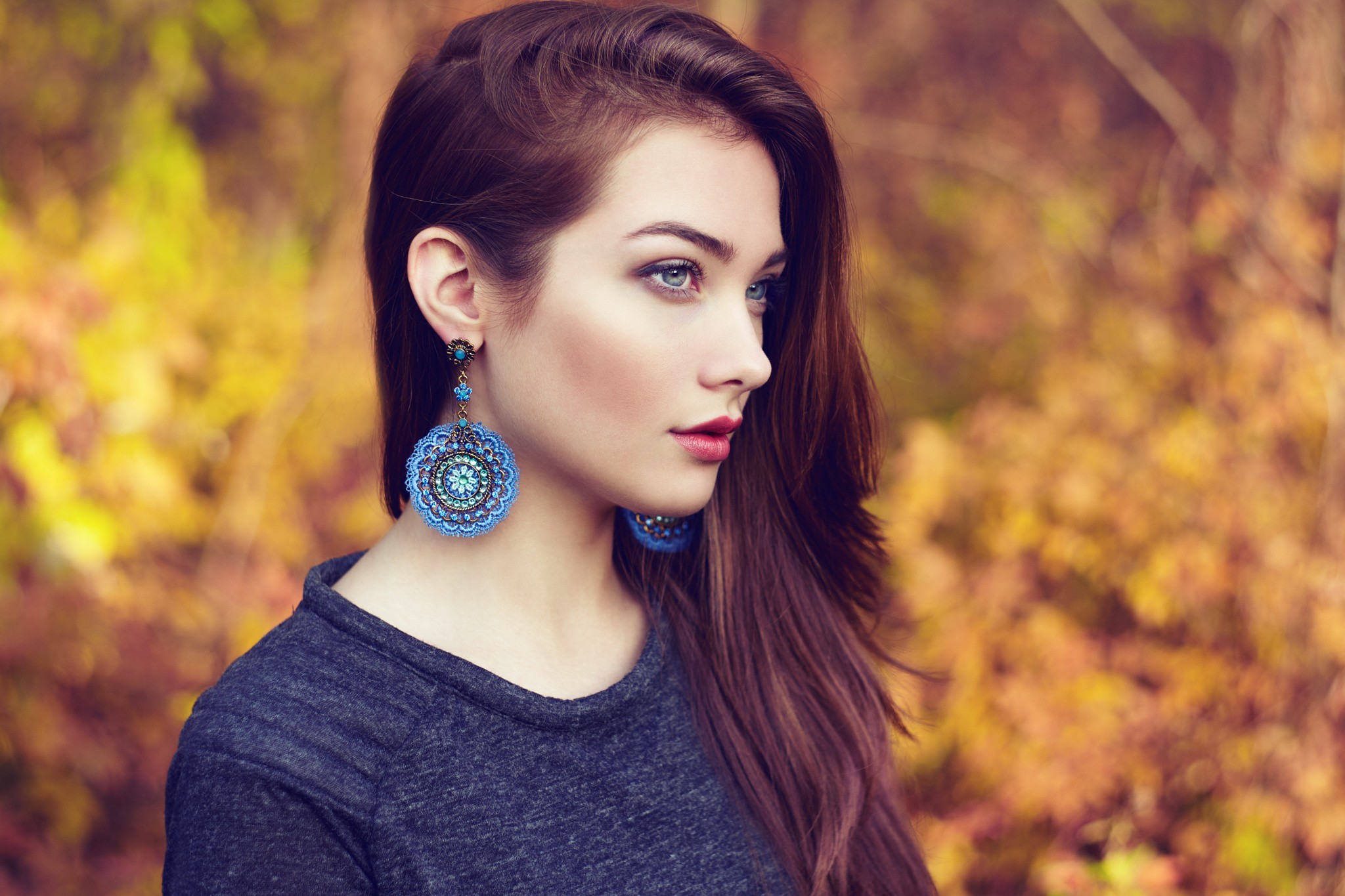 Woman with long brown hair and blue earrings HD Wallpaper
