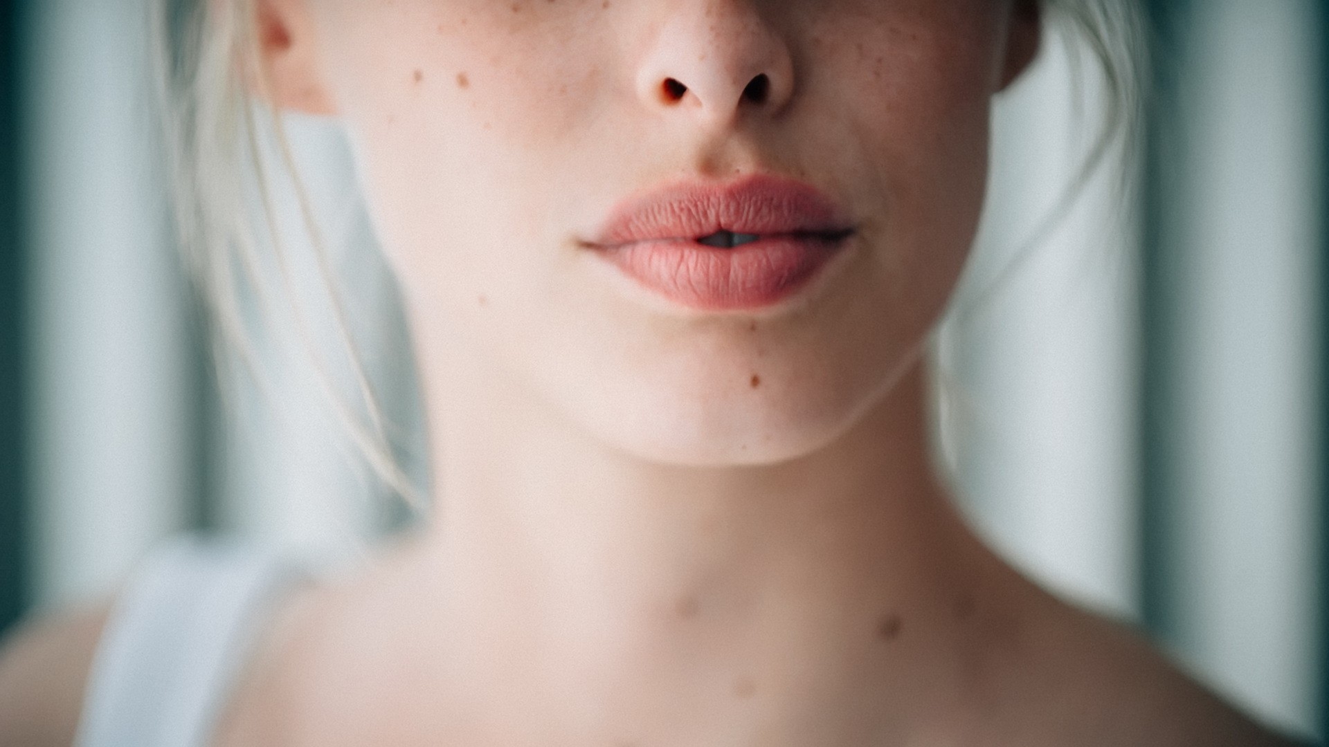 Close-up of a woman's face with freckles and moles HD Wallpaper