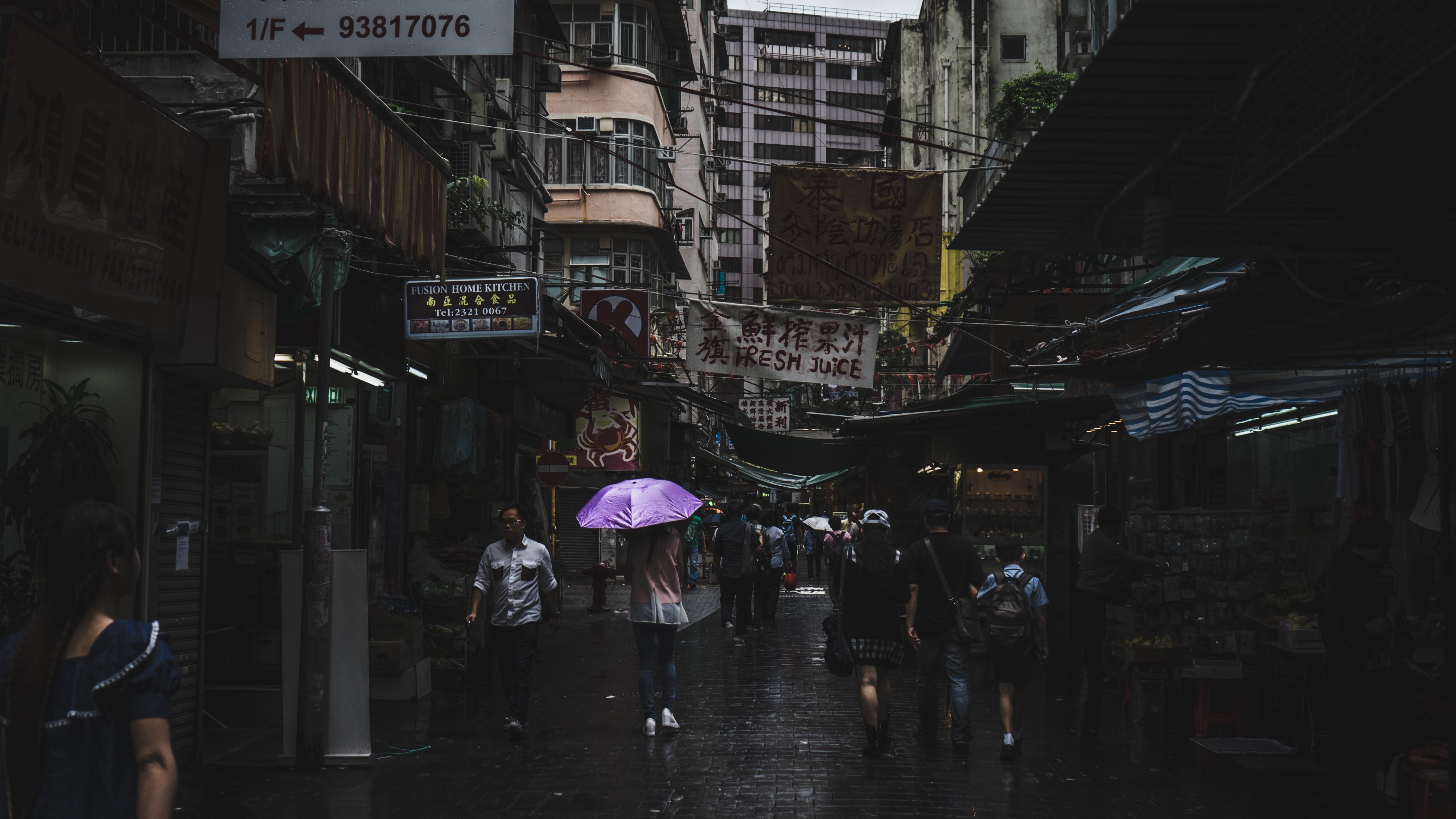 People walking through a busy street market in a city HD Wallpaper