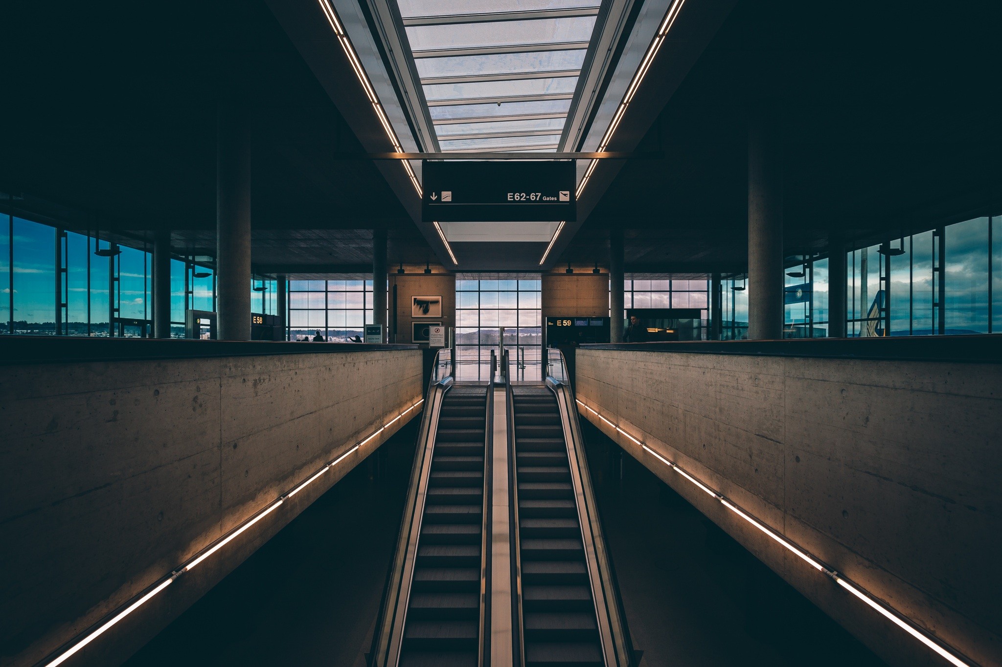 Escalators in a modern airport terminal HD Wallpaper