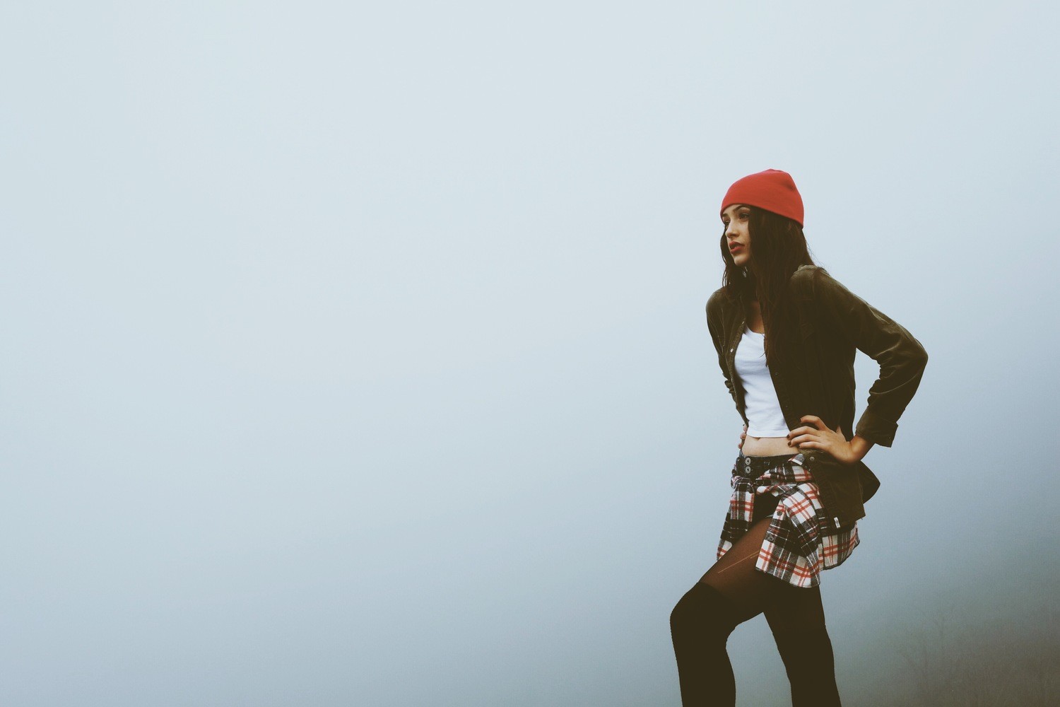 Woman in red hat and plaid skirt in mist HD Wallpaper