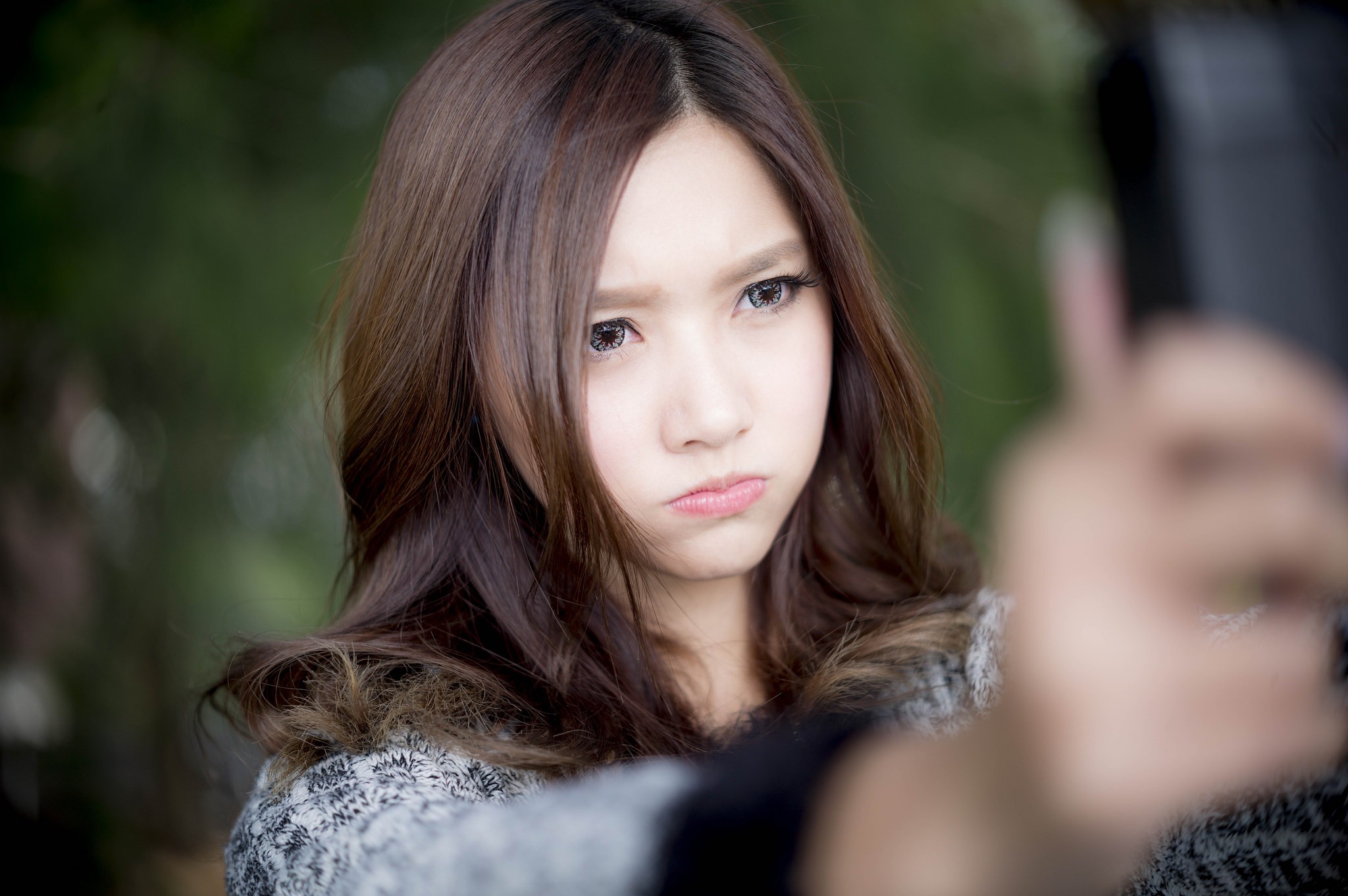 Asian woman taking a selfie with a pout HD Wallpaper