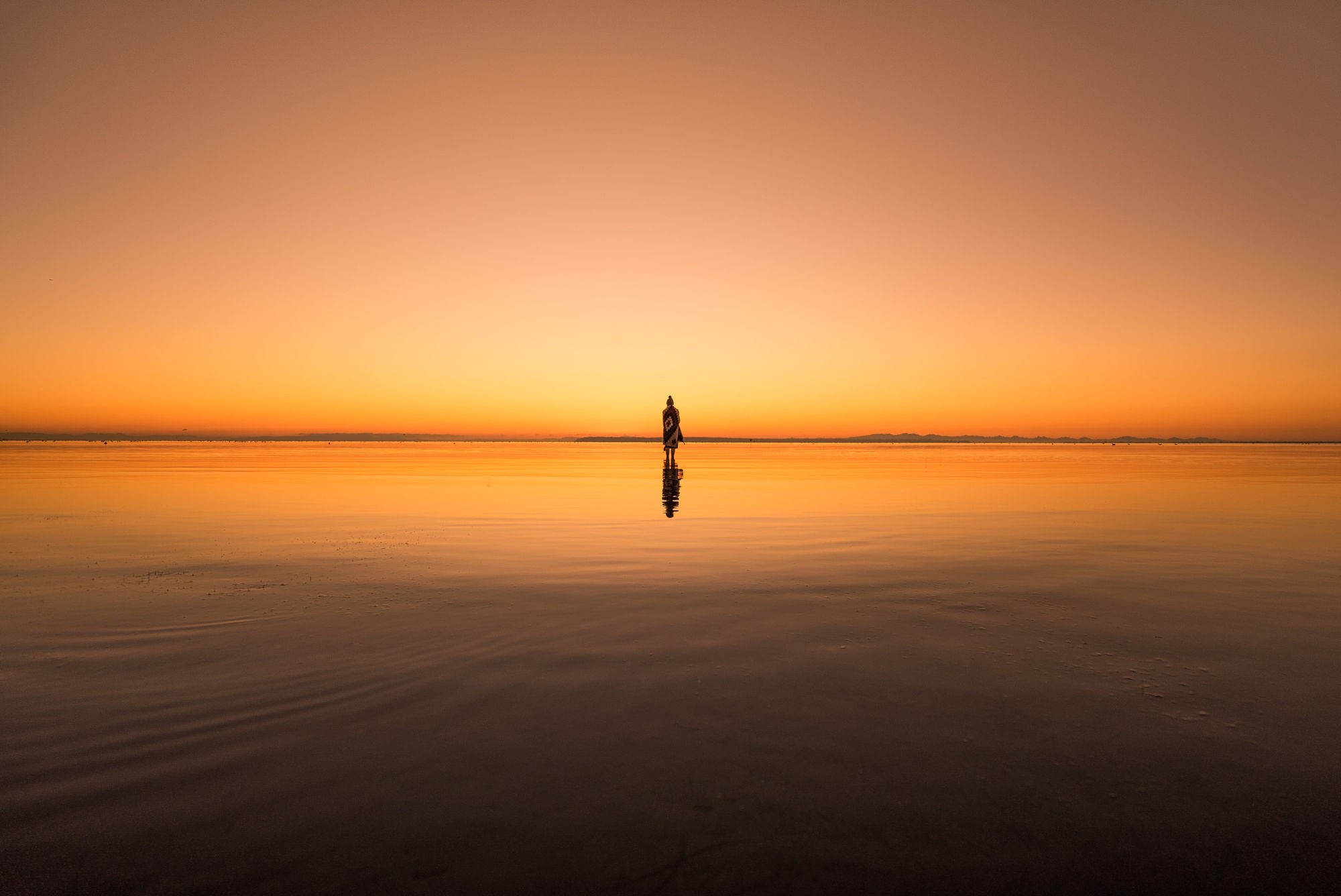 Woman standing in the ocean at sunset HD Wallpaper