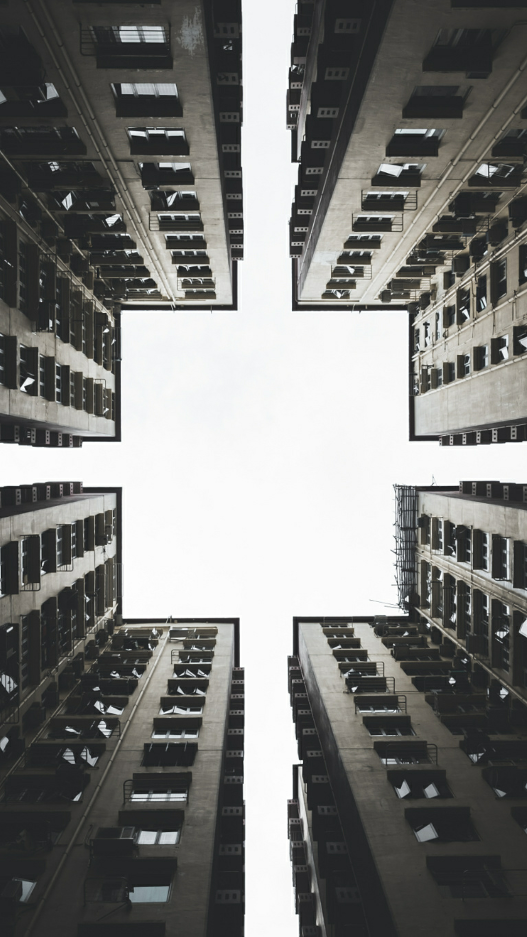 Looking up at apartment buildings forming a cross shape HD Wallpaper