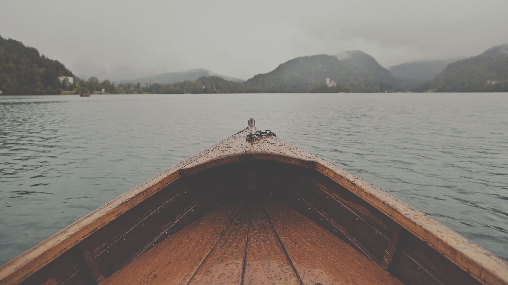 Wooden boat on a lake with mountains HD Wallpaper