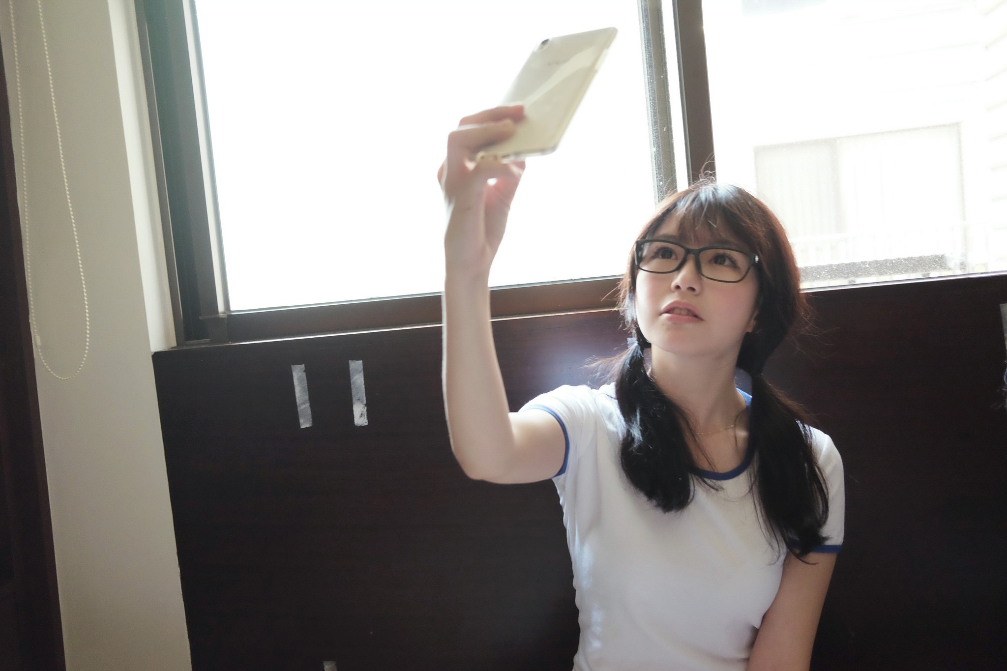 Asian girl taking a selfie by the window HD Wallpaper