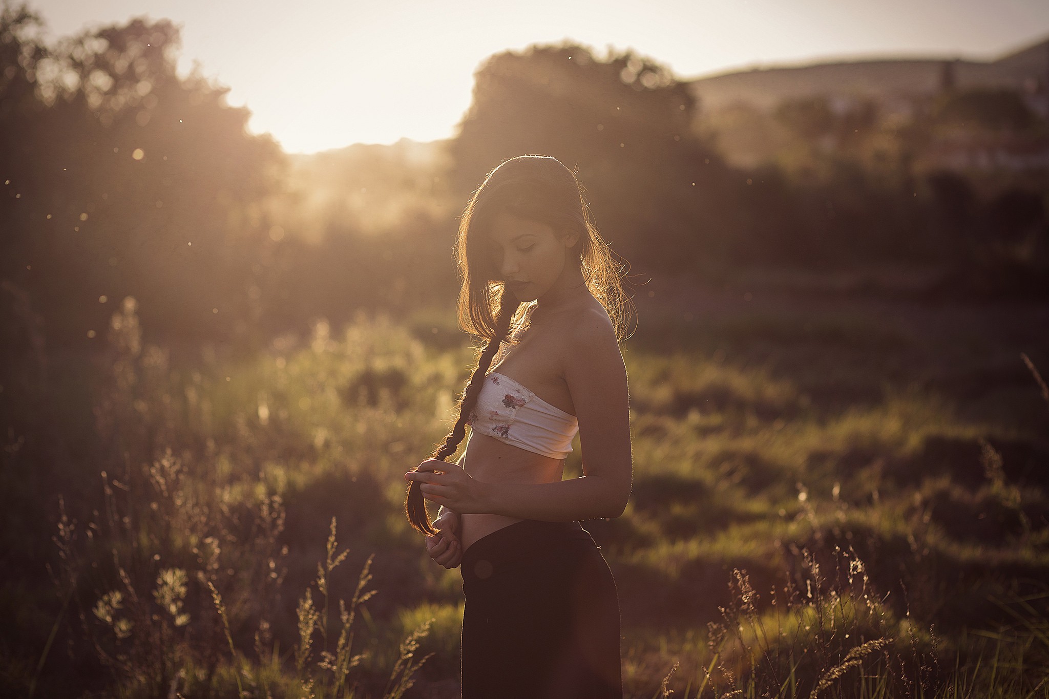 Woman with braid in a field at sunset HD Wallpaper