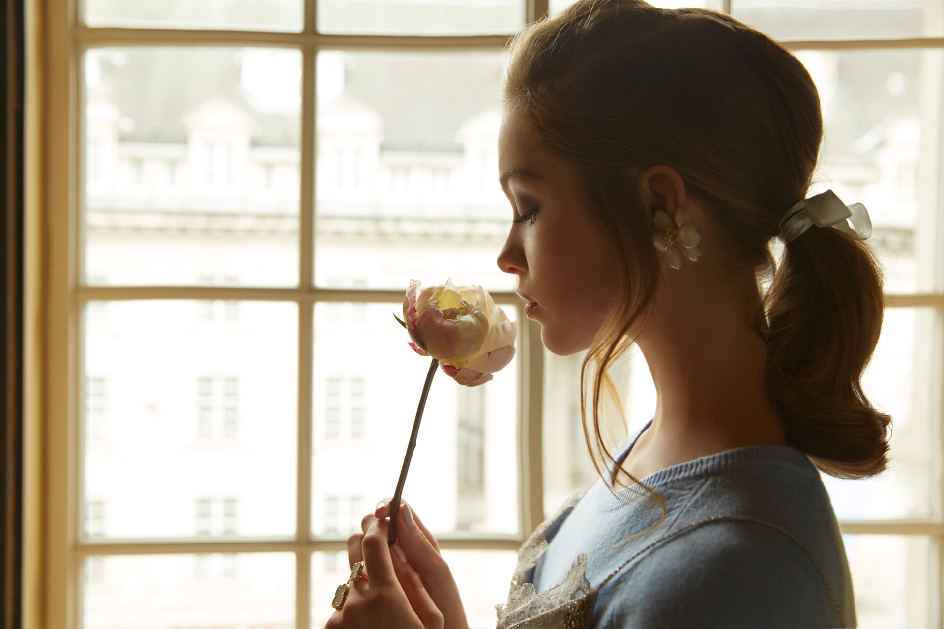 Woman with auburn hair smelling a flower HD Wallpaper