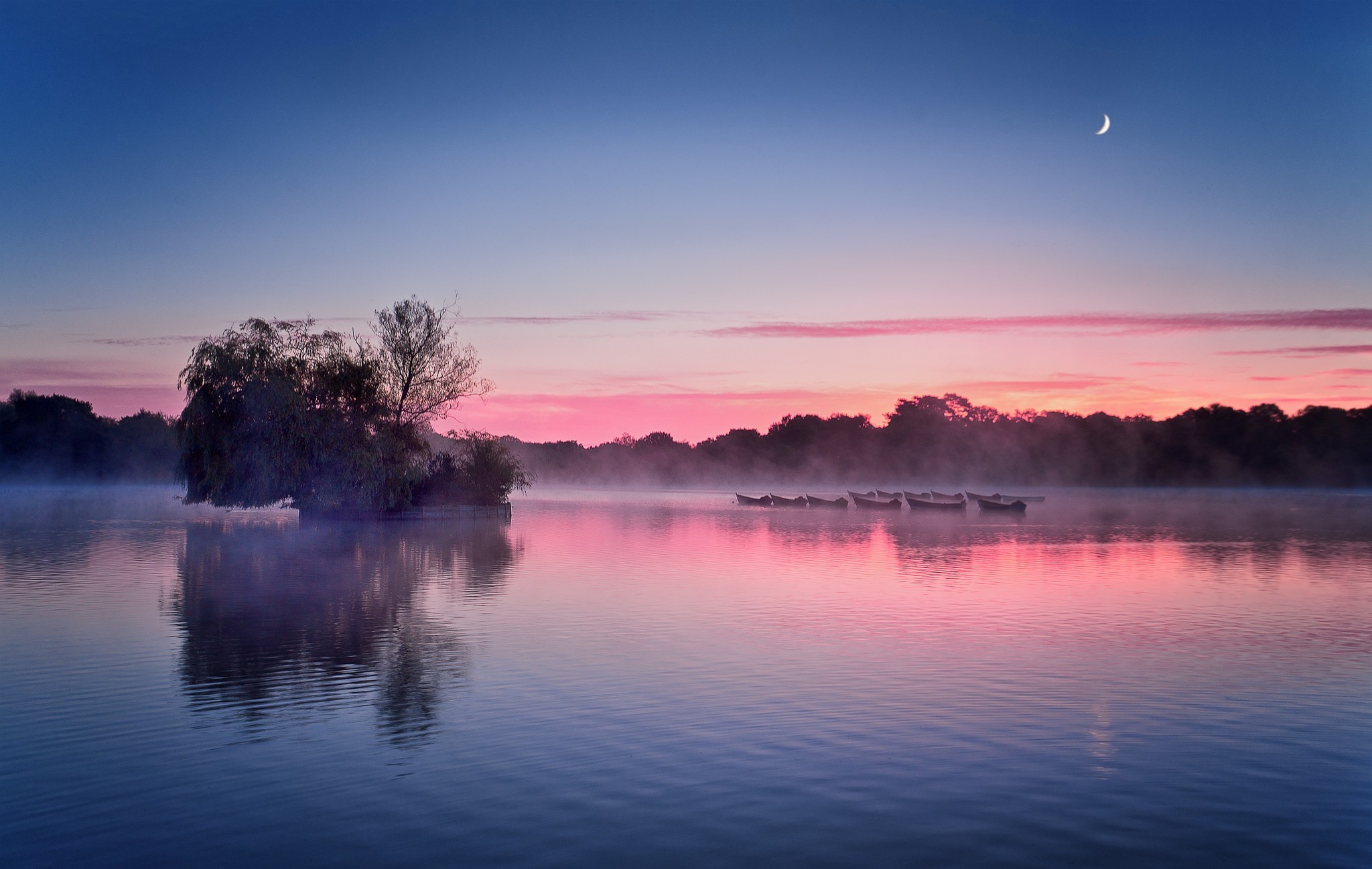 Misty lake with boats and island at sunrise HD Wallpaper