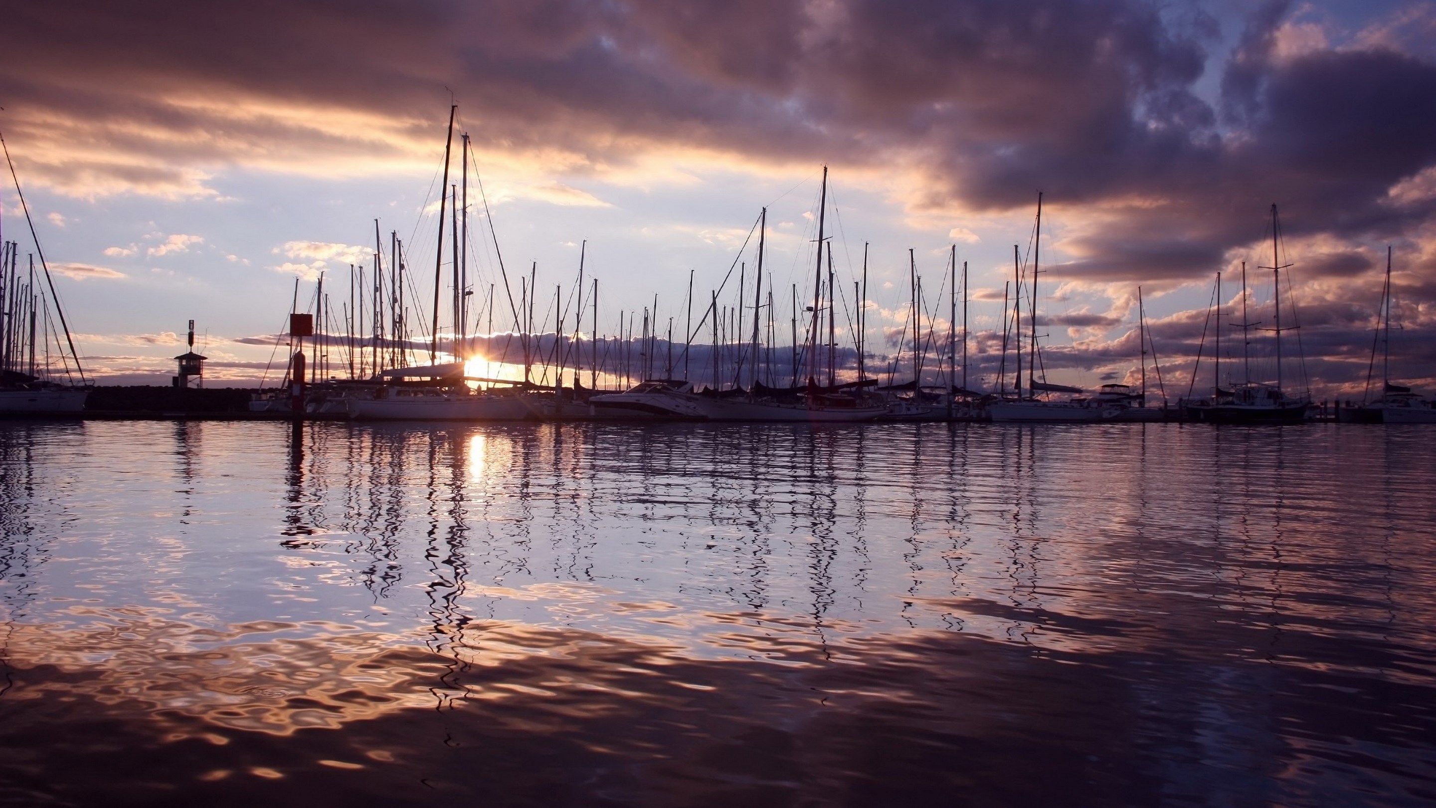 Sailboats docked in a harbor at sunset HD Wallpaper