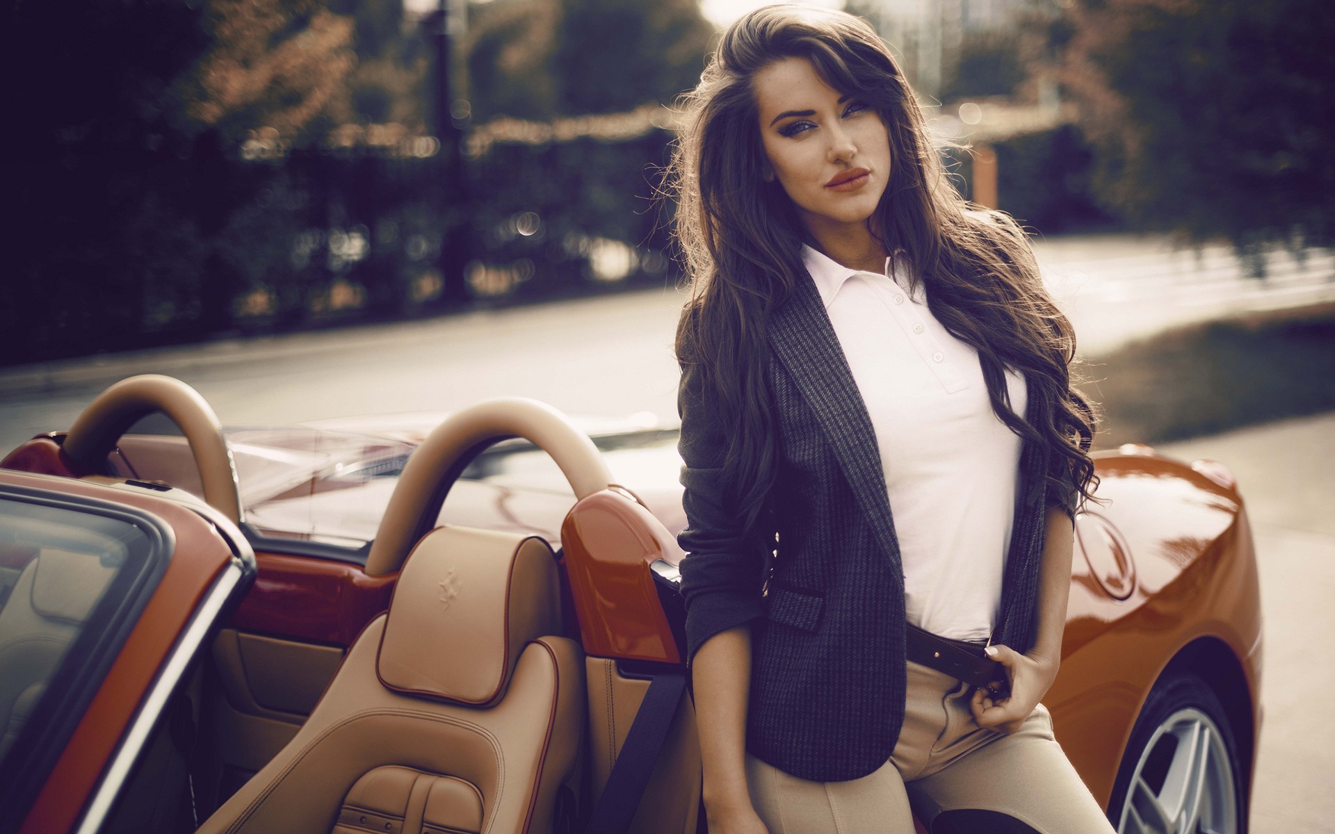 Woman in blazer leaning on a red Ferrari convertible HD Wallpaper
