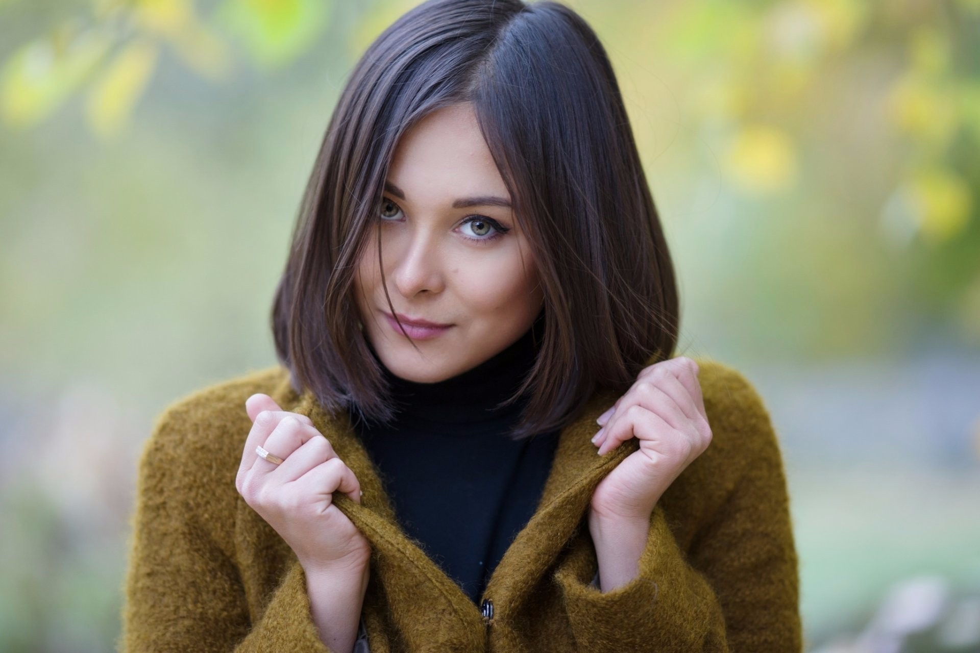 Woman with dark hair wearing a mustard cardigan HD Wallpaper