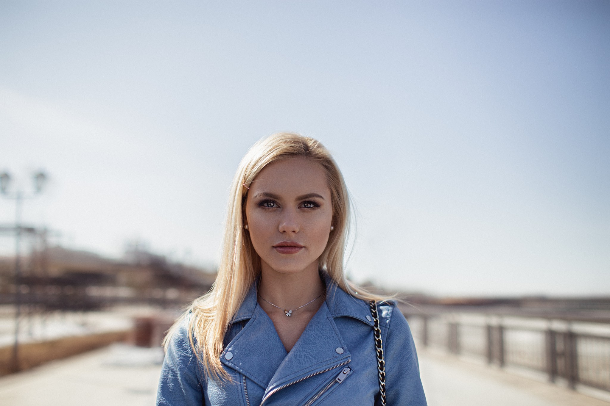 Blonde woman in a blue jacket outdoors HD Wallpaper