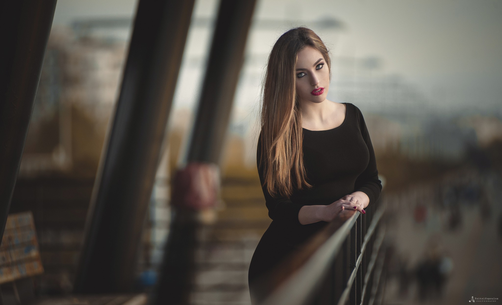 Woman with long blonde hair in a black dress on a balcony HD Wallpaper