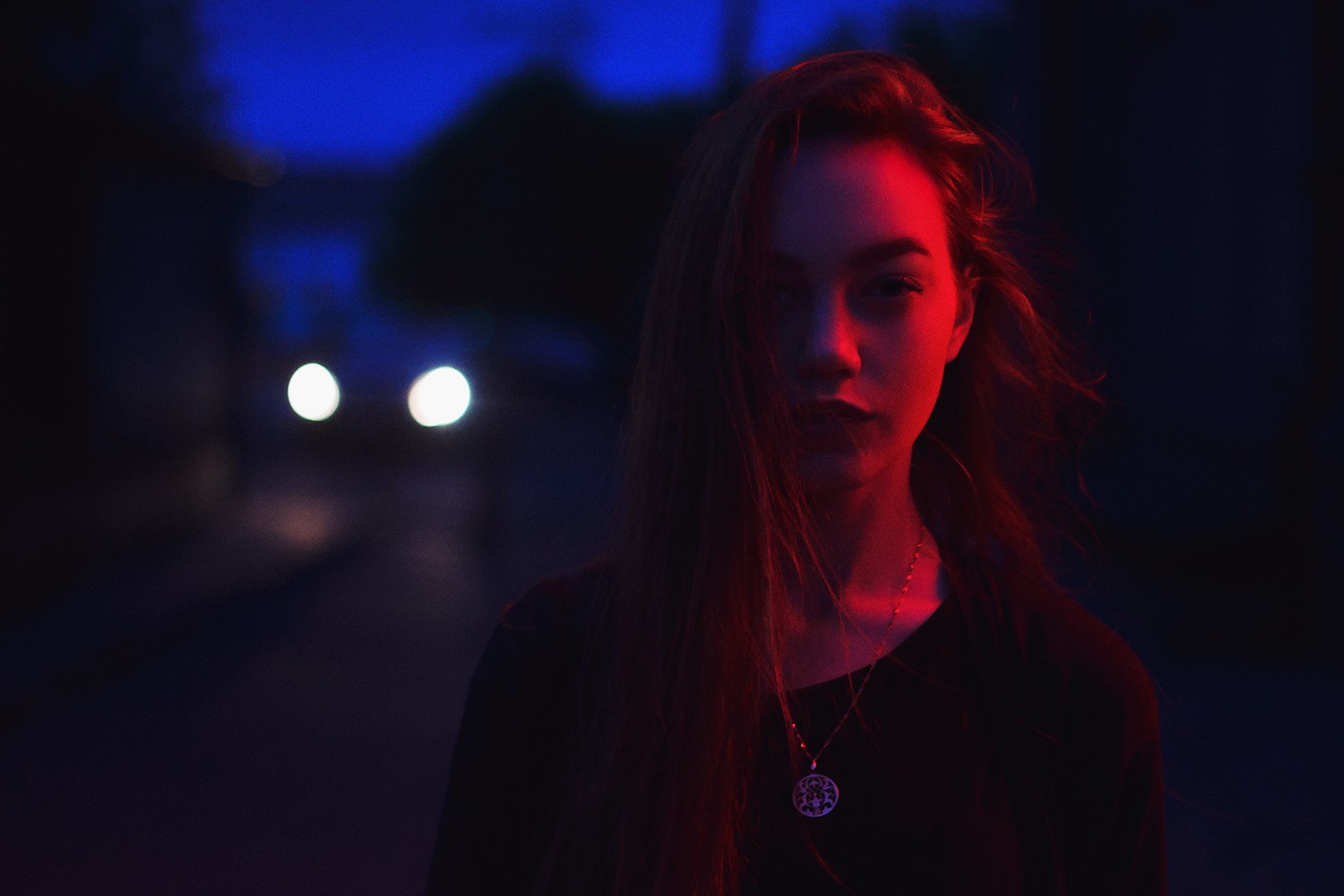 Woman illuminated by red and blue light at night HD Wallpaper