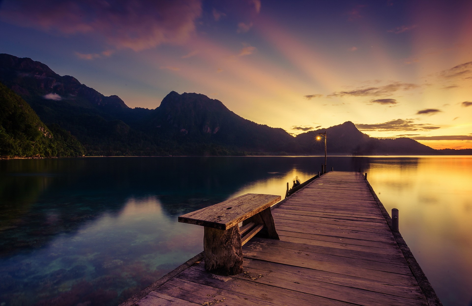 Wooden pier with bench on a lake at sunset HD Wallpaper