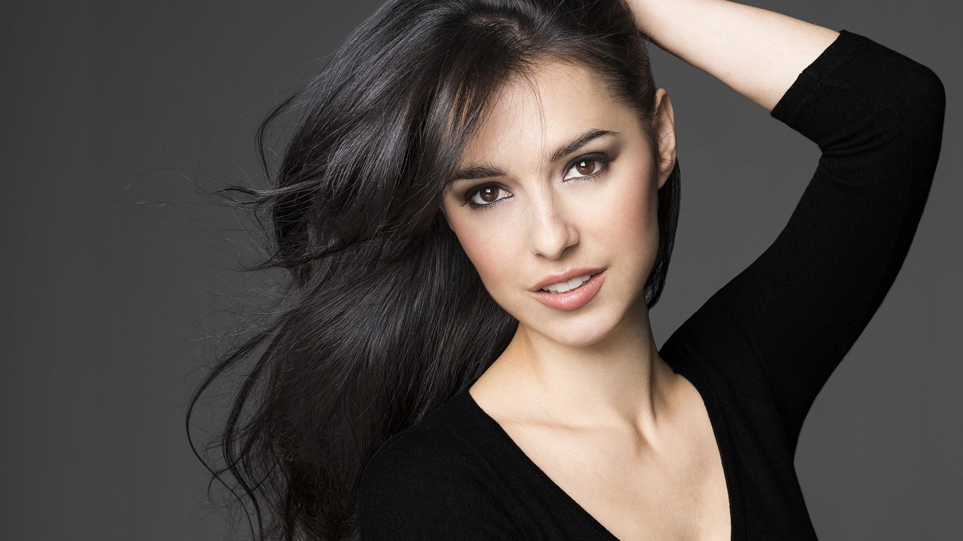 Woman with long dark hair and black top HD Wallpaper