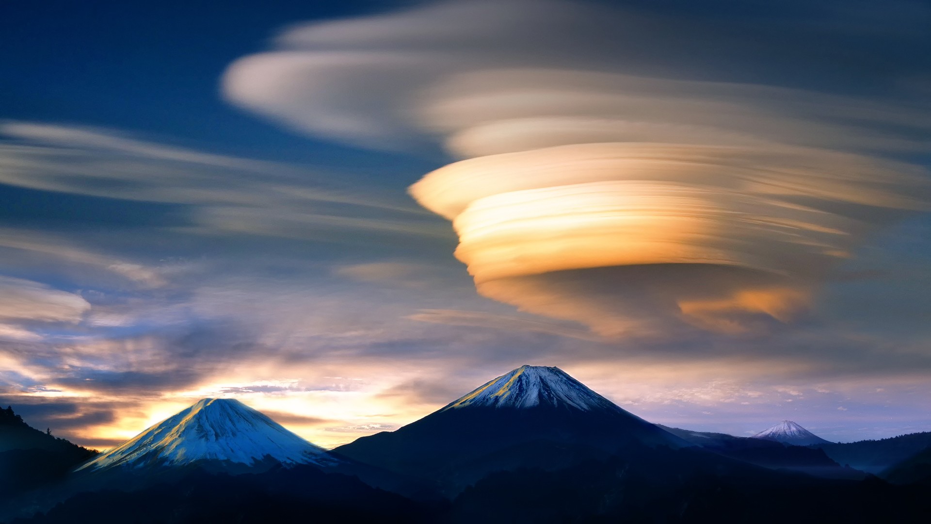 Lenticular clouds over mountains at sunset HD Wallpaper