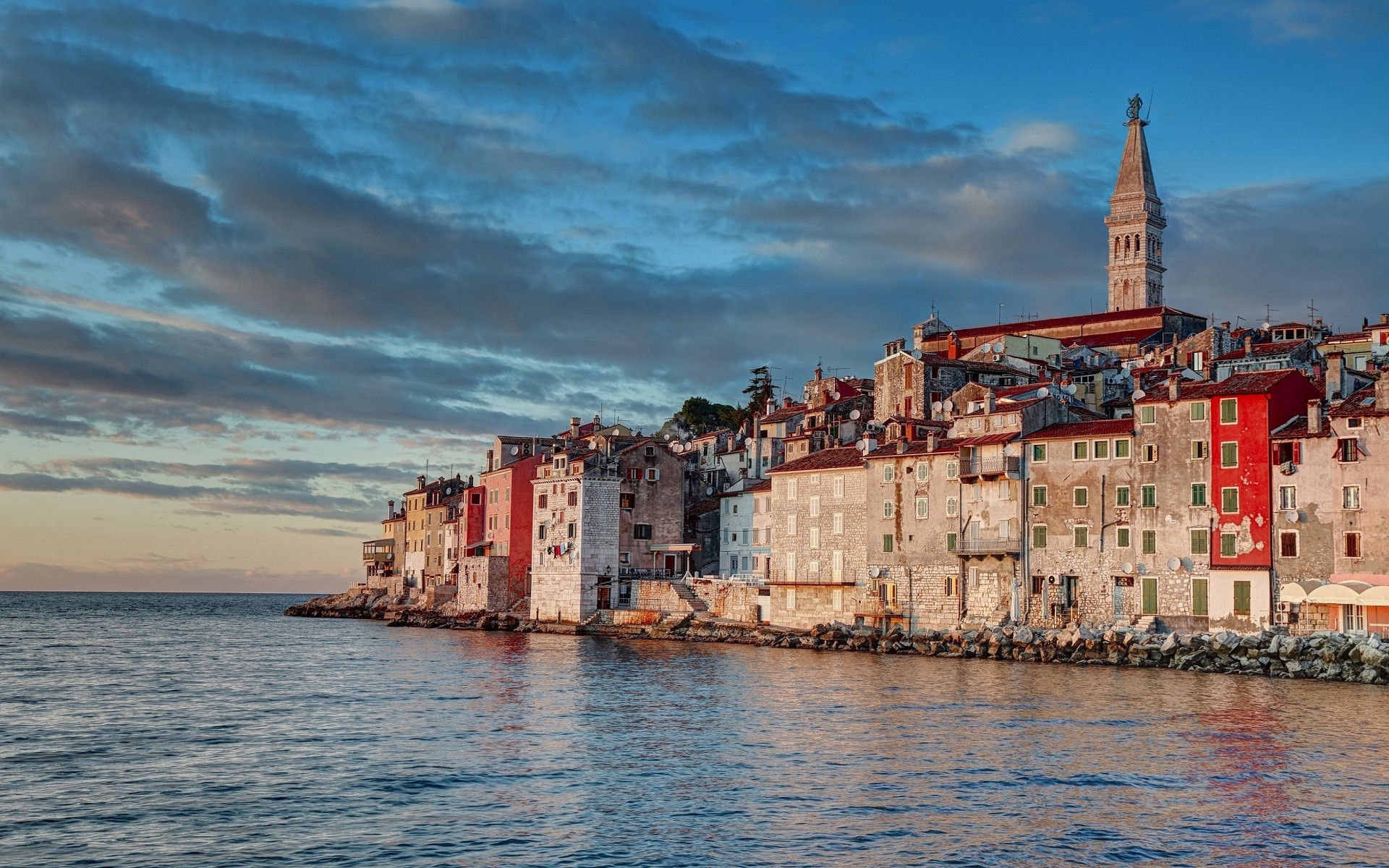 Coastal city with a prominent tower and the sea HD Wallpaper