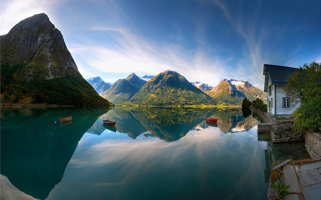 Panoramic view of a Norwegian fjord with mountains and a house HD Wallpaper
