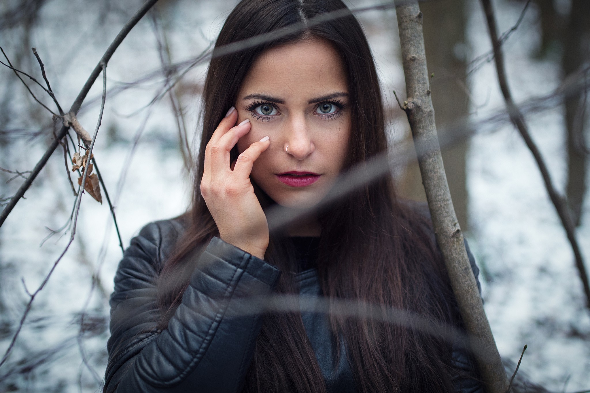 Woman with dark hair and blue eyes in a forest HD Wallpaper
