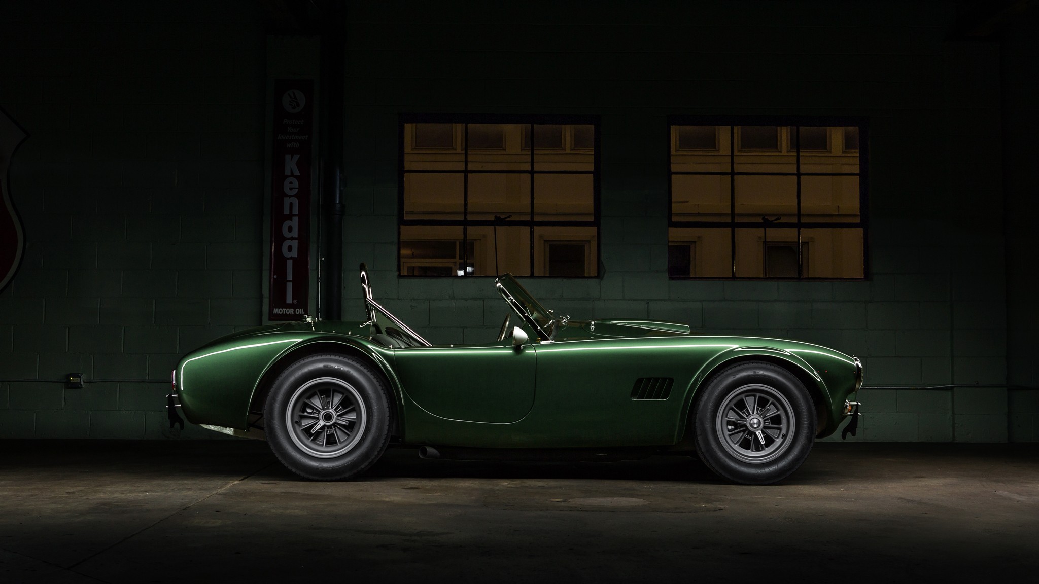 Green Shelby Cobra parked in a garage HD Wallpaper