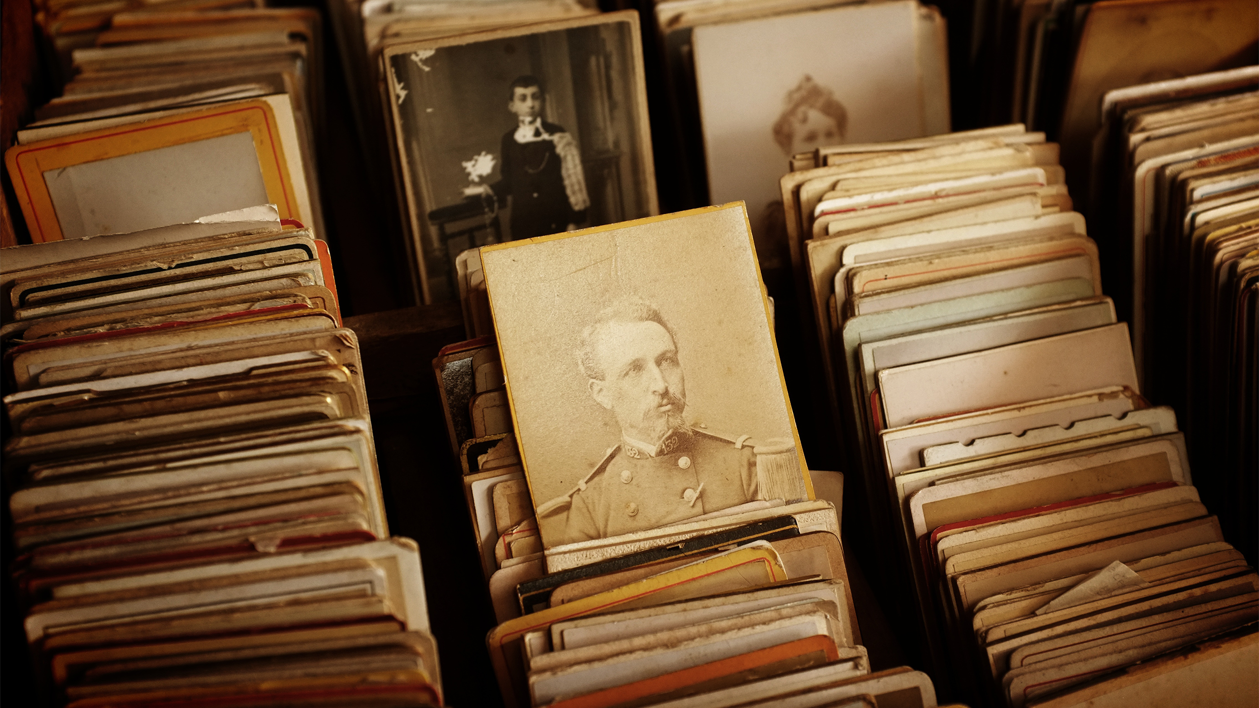A collection of old photographs in a drawer HD Wallpaper