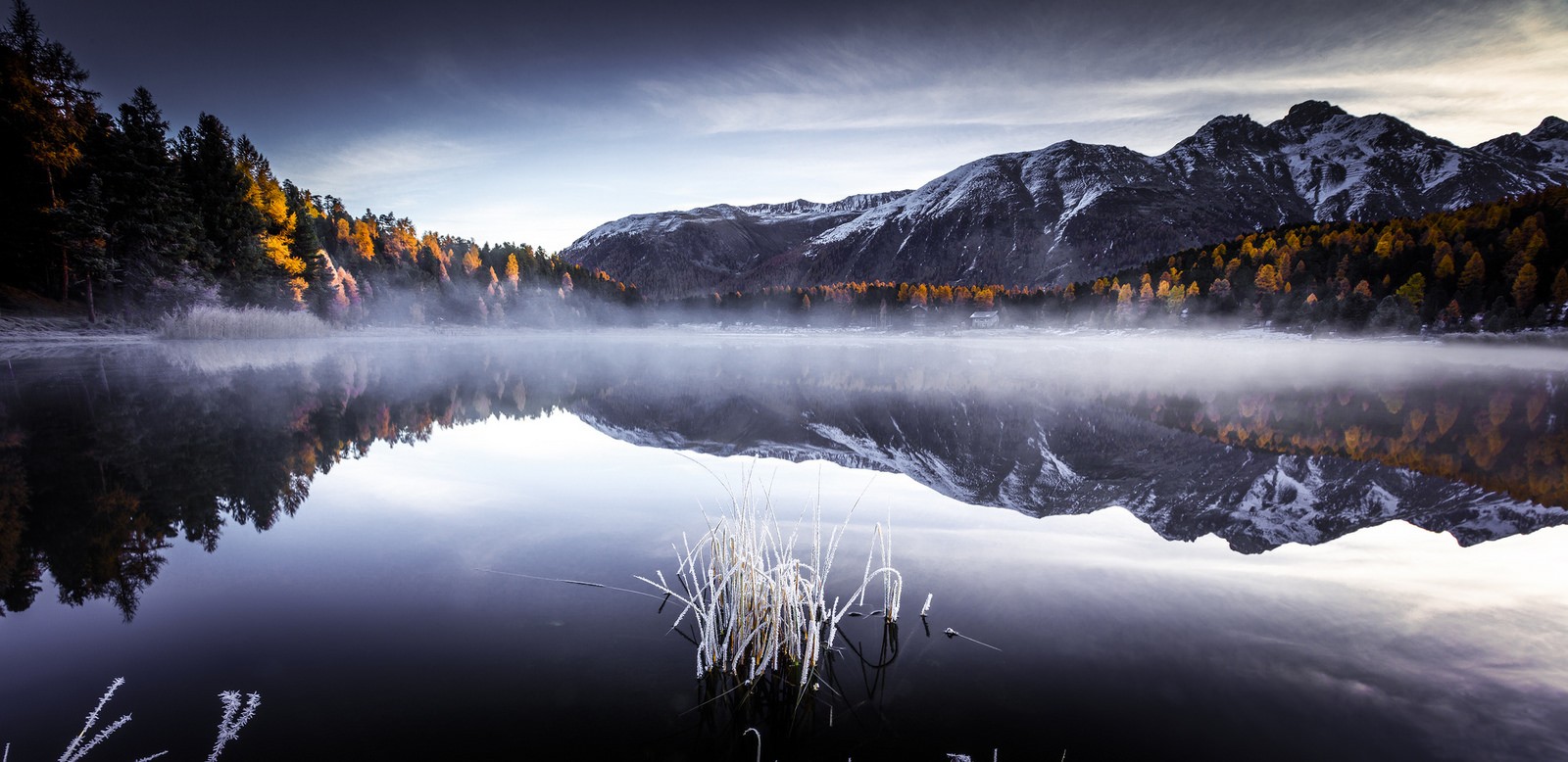 Misty lake reflecting mountains and autumn trees HD Wallpaper