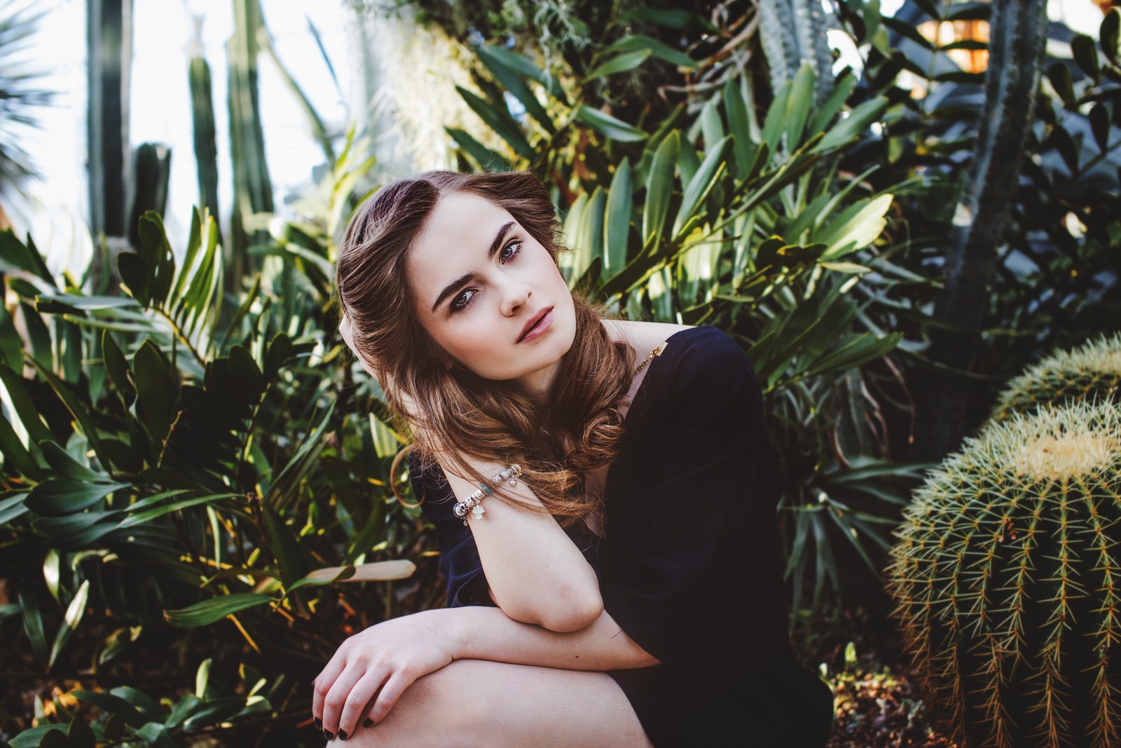 Woman posing in a botanical garden with cacti HD Wallpaper